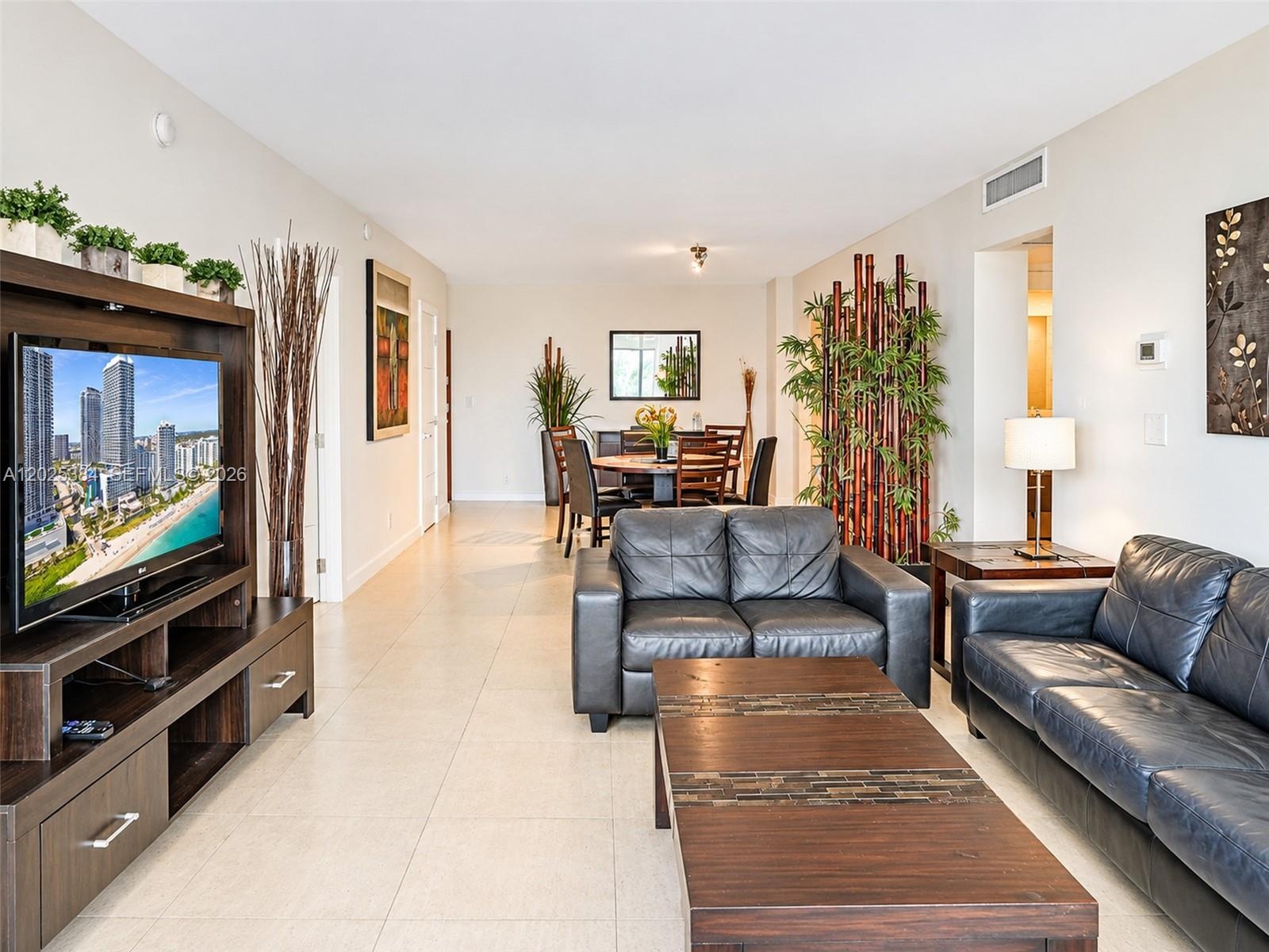 Open-concept interior featuring large-format tile flooring and neutral wall finishes