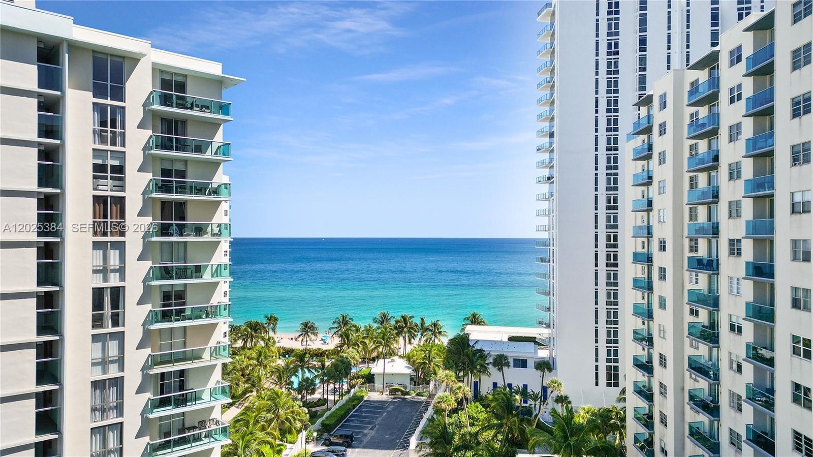 High-rise exterior featuring stacked balconies with glass railings and unobstructed ocean frontage