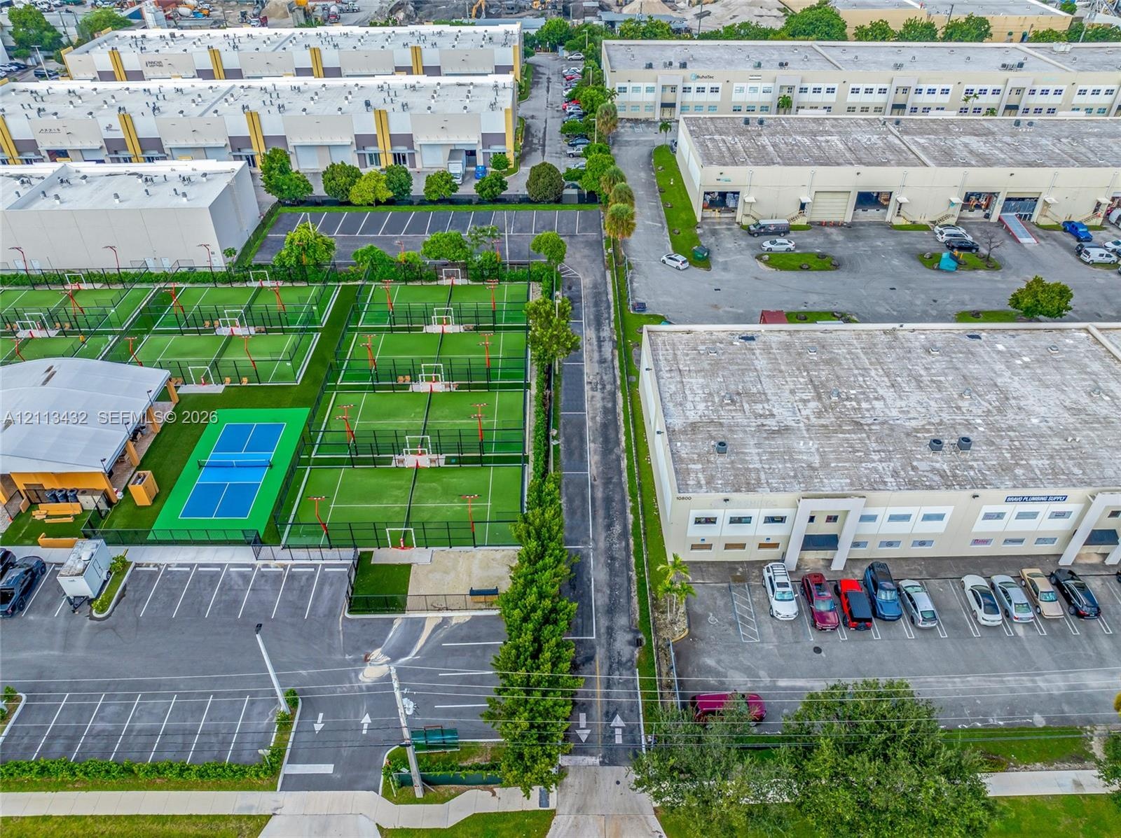 Perimeter fencing, paved parking areas, and mature landscape border trees