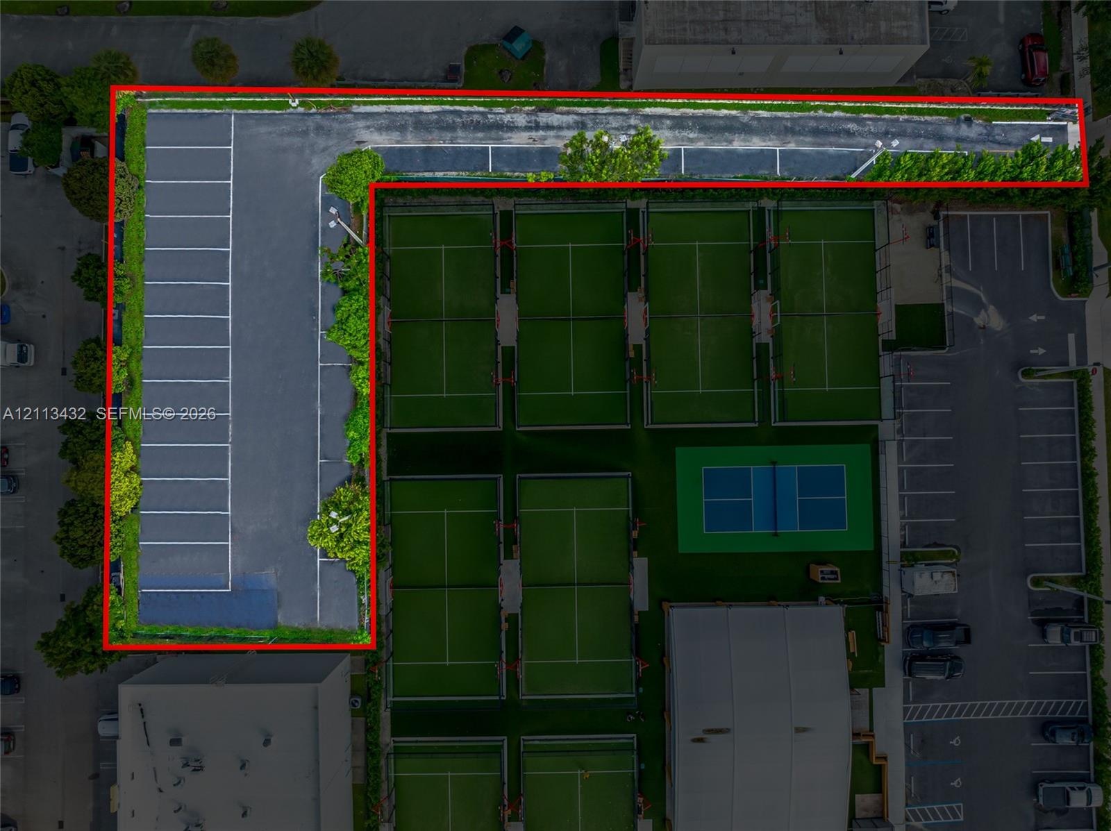 Aerial perspective featuring asphalt paved parking area with perimeter landscaping