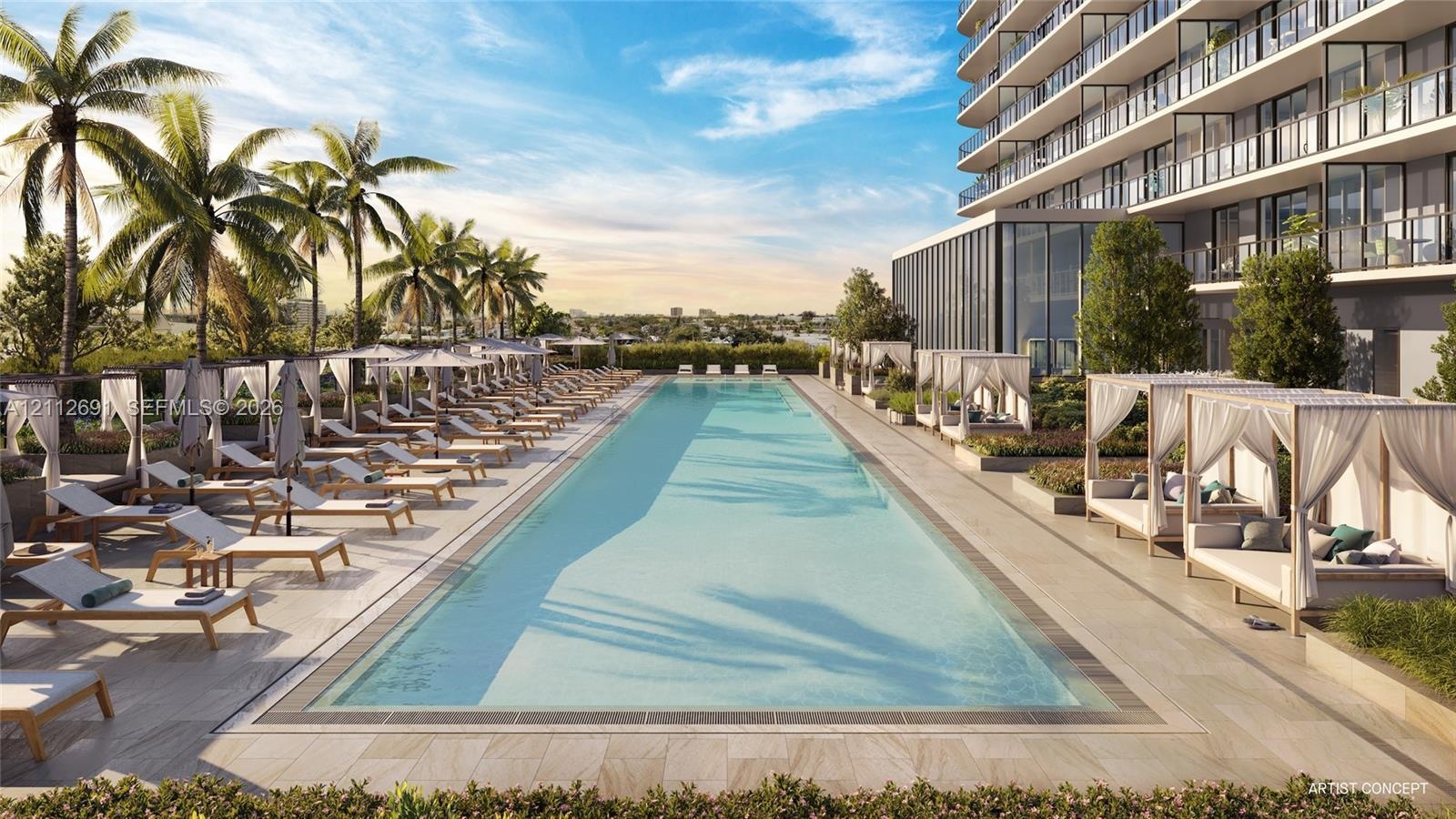 Olympic-length swimming pool featuring a stone-tiled deck and built-in cabana structures