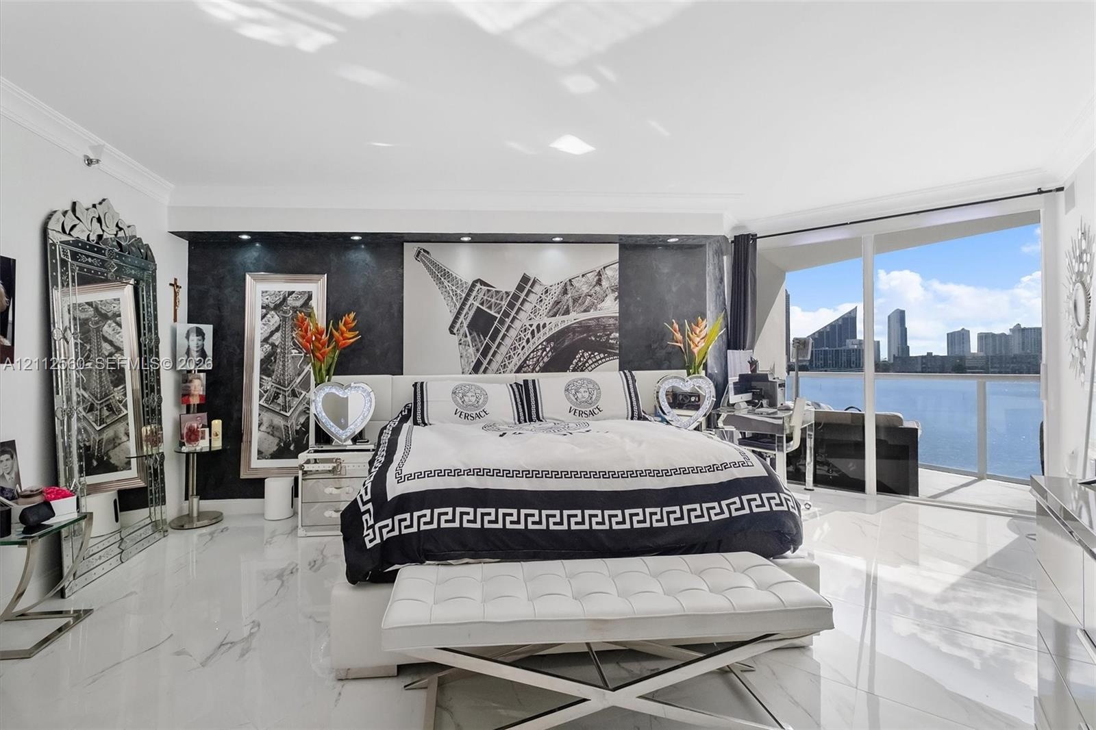 High-gloss tile flooring, floor-to-ceiling glass sliding doors, recessed ceiling lighting, and a dark stone-finish accent wall