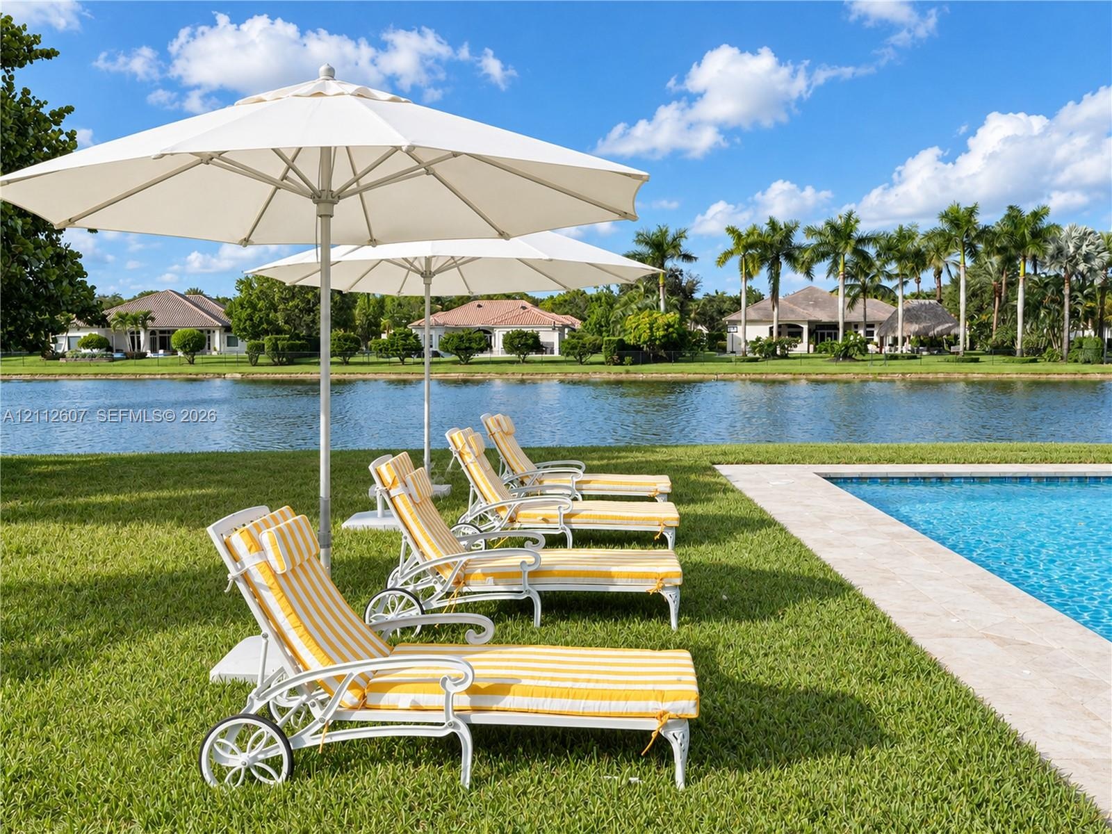 Swimming pool with natural stone decking and expansive waterfront lawn