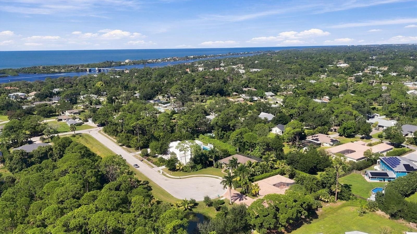 Privacy abounds with lushly landscaped grounds and a non-buildable privacy easement directly across the street