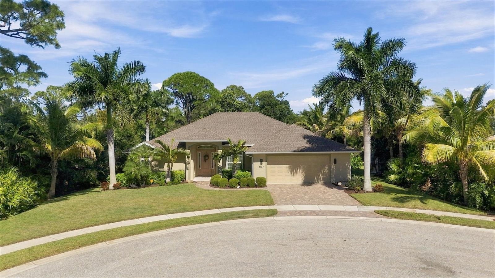 Mature tropical landscaping compliment this magnificent residence