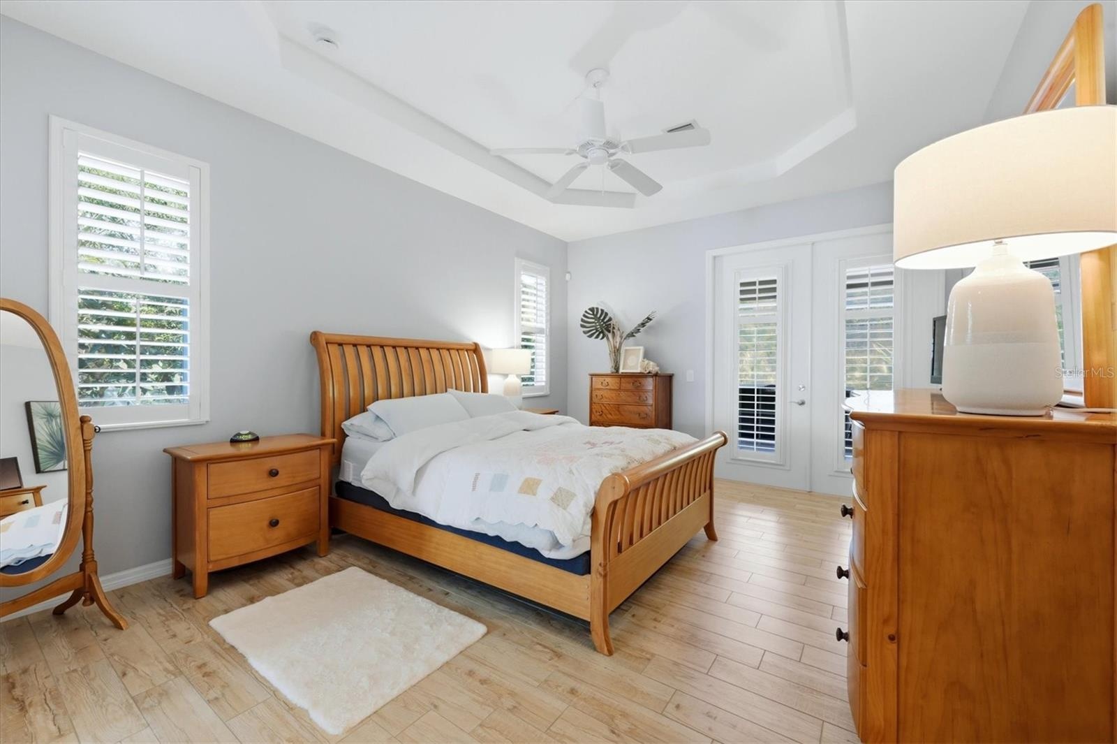Primary Suite provides direct access to the lanai, pool and Jacuzzi/spa