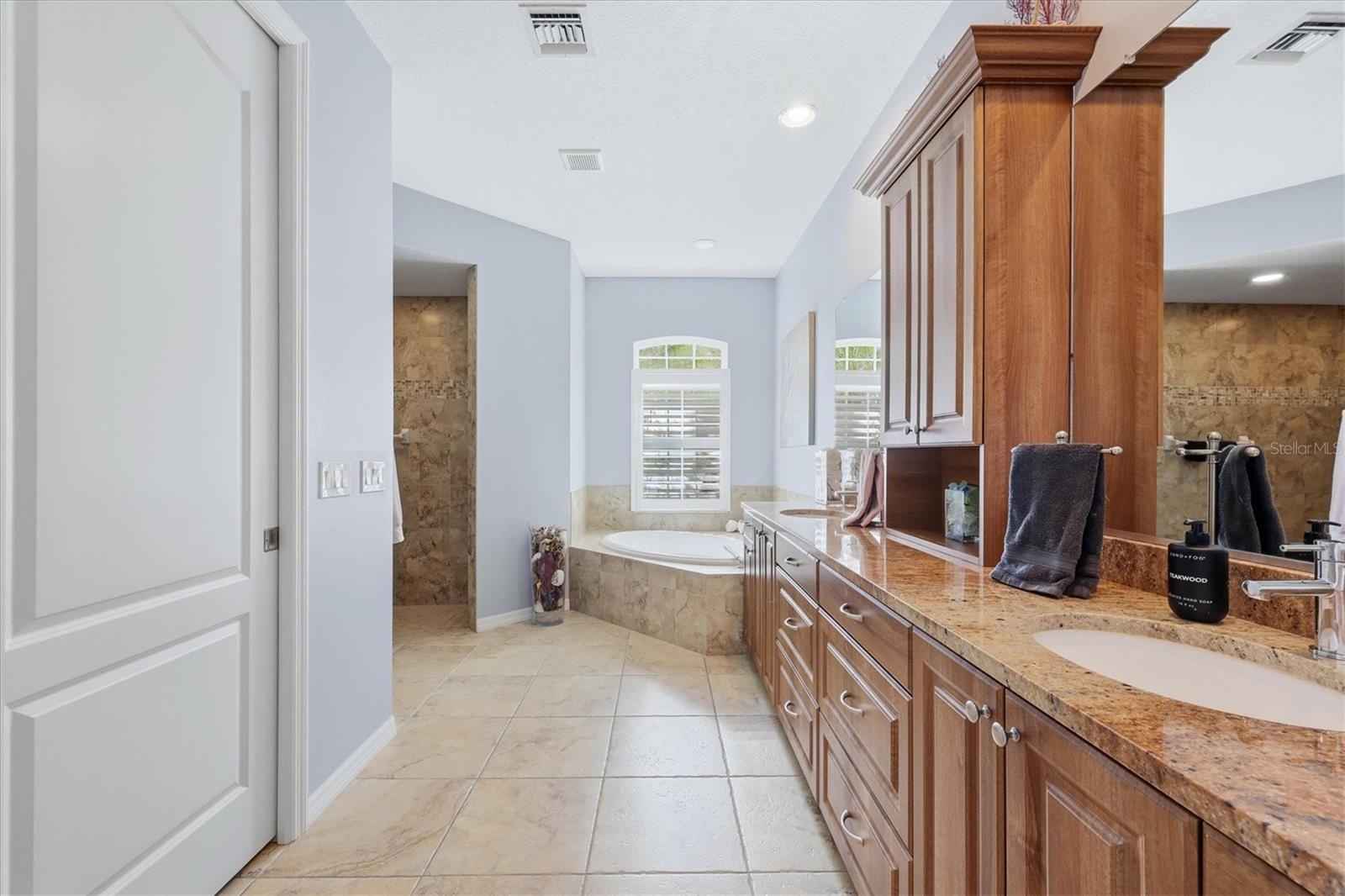 Primary Bath features a walk-in shower and separate tub