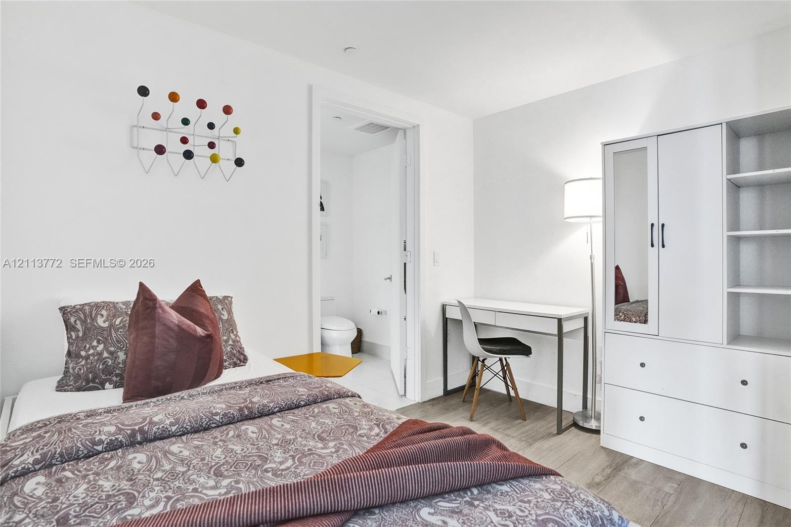 Room with wood-finish flooring and neutral wall tones