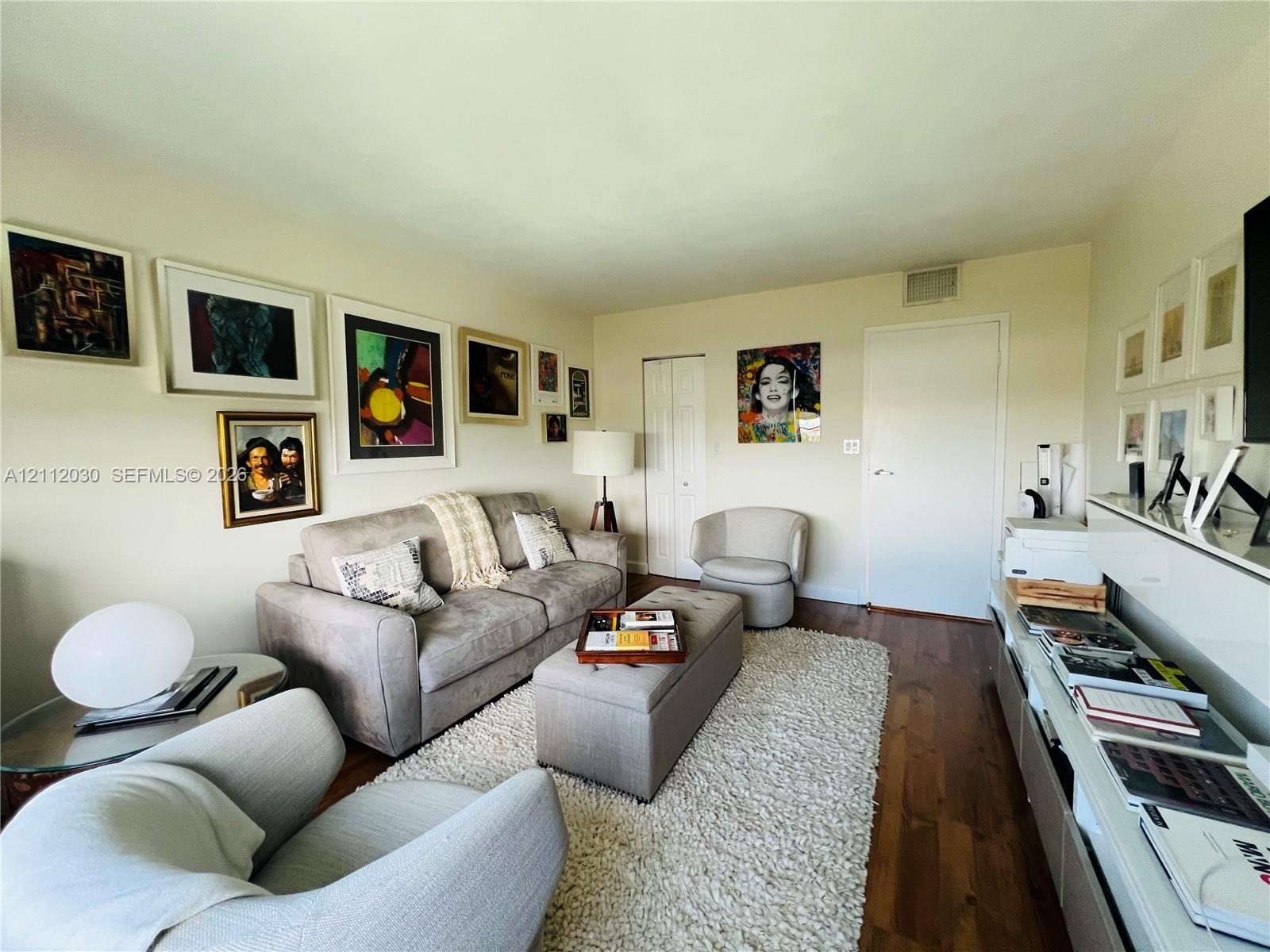 Living space featuring wood-finish flooring and double-panel closet doors