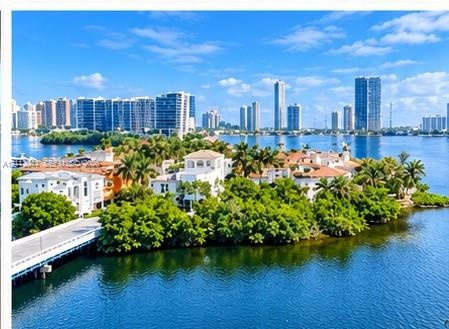 Waterfront estate featuring deep-water access, multi-story Mediterranean-style architecture, tile roofing, private bridge entry, and mature tropical l