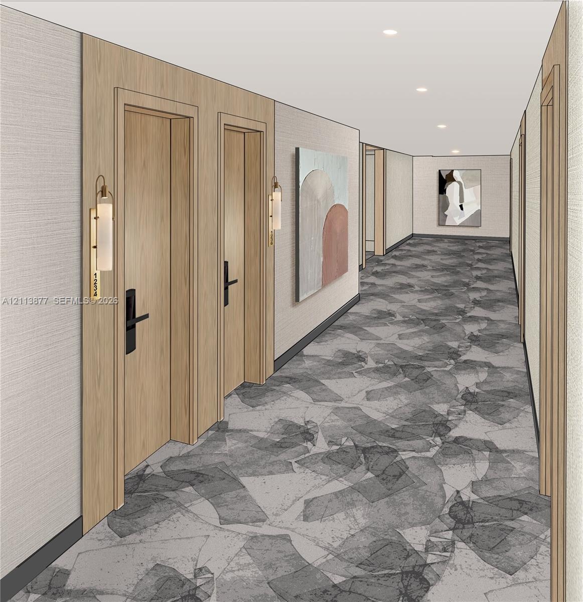 Hallway featuring light wood-finish door frames, recessed ceiling lighting, patterned wall-to-wall carpeting, and wall-mounted metallic sconces