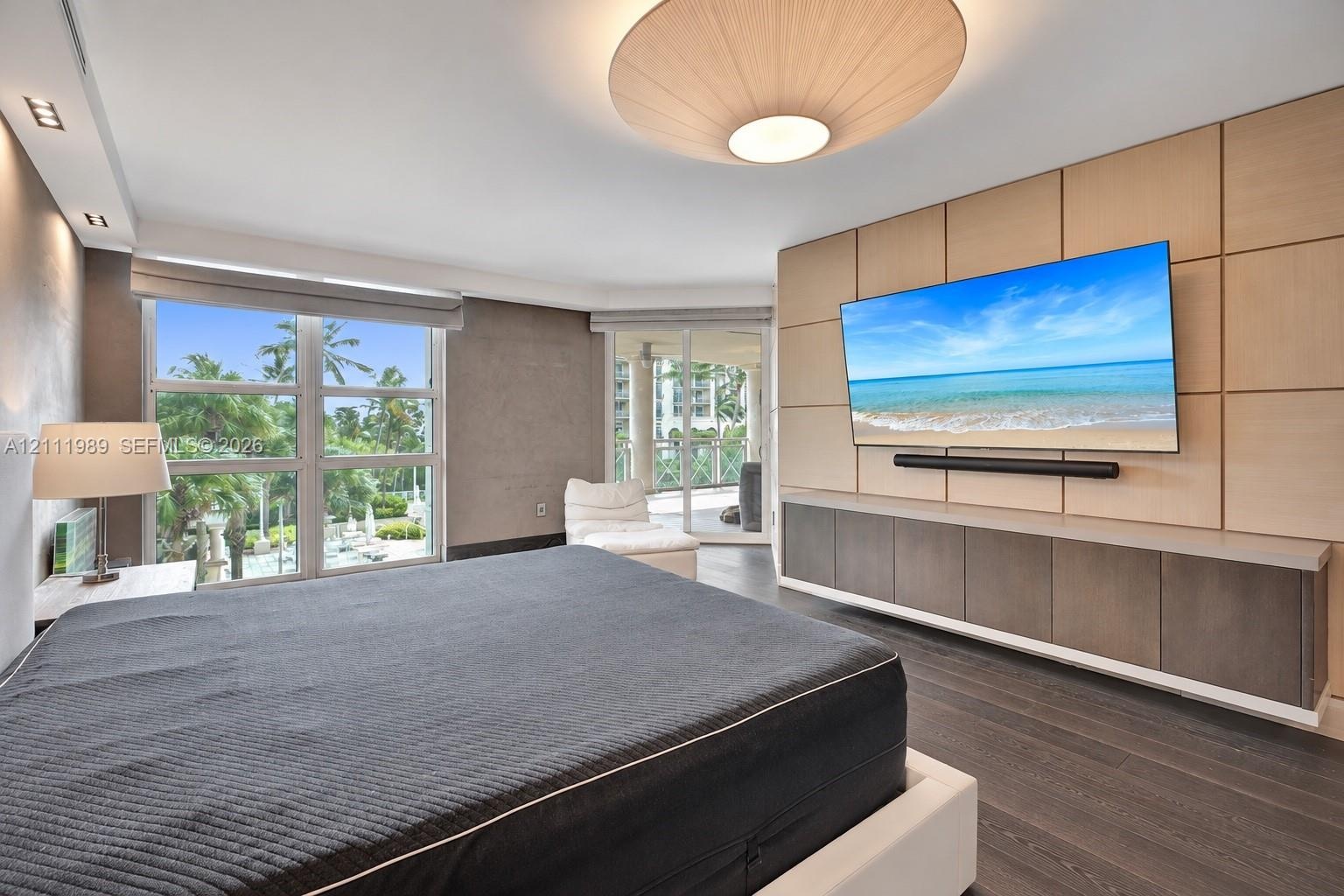 Large-format windows, custom paneled accent wall, floating cabinetry, recessed ceiling lighting, and wood-finish flooring