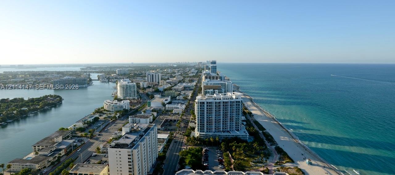 Aerial perspective featuring coastal shoreline, oceanfront geography, urban skyline, and inlet waterways