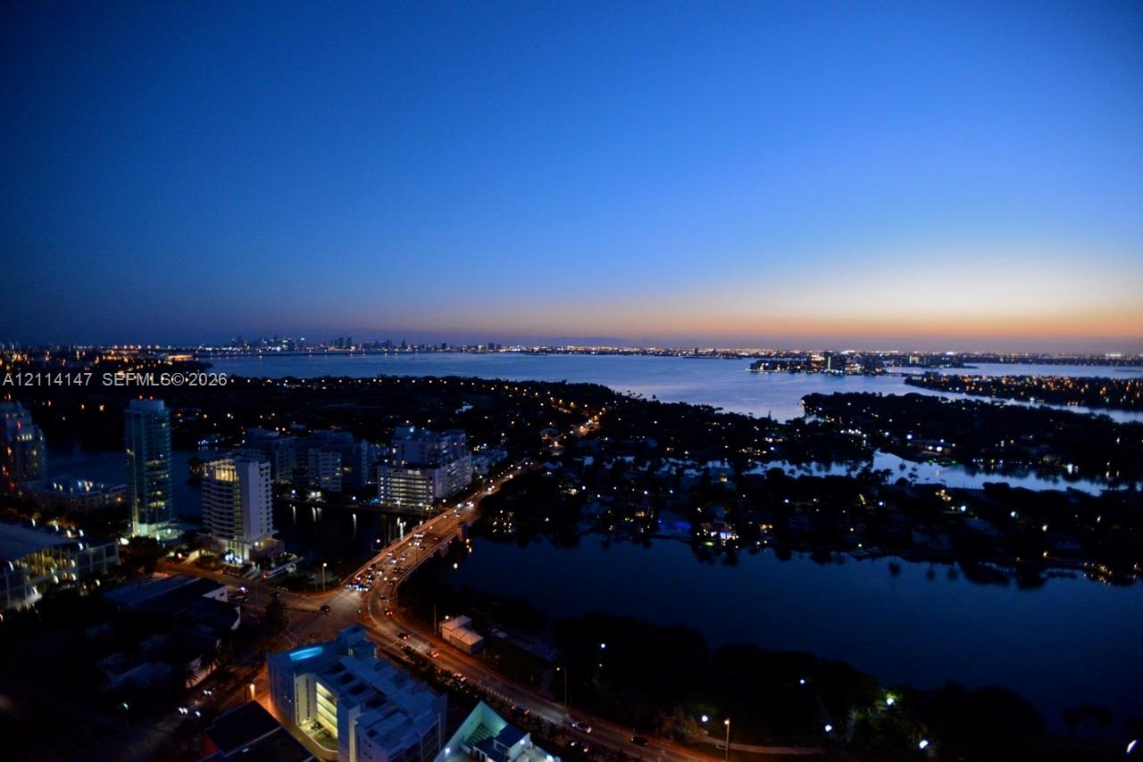 Elevated perspective featuring coastal waters, urban skyline, and bridge infrastructure