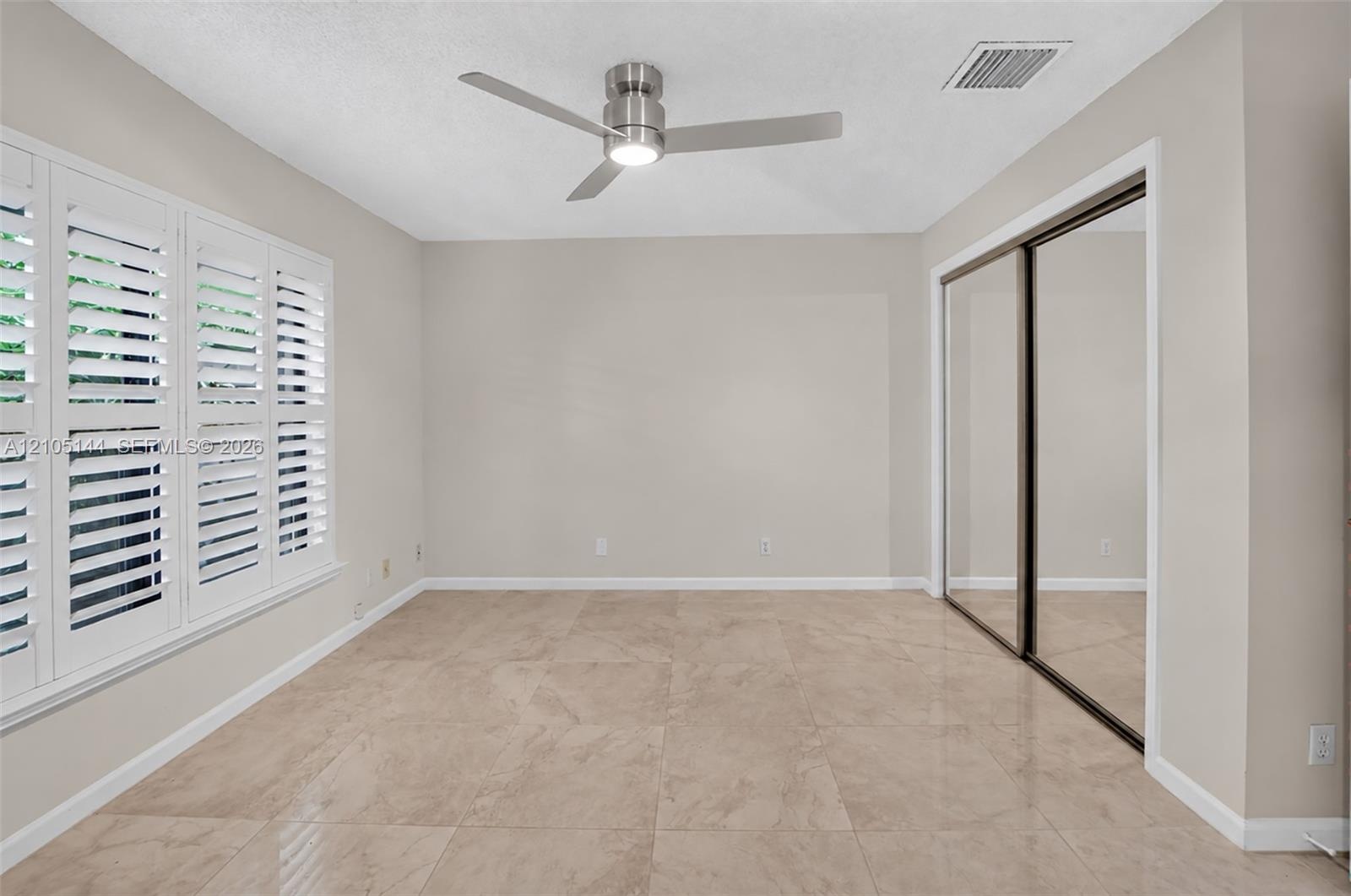 (FAN VIRTUALLY STAGED AS SIMILAR PIECE WILL BE INSTALLED)Large-format tile flooring, multi-panel plantation shutters, ceiling fan with integrated ligh