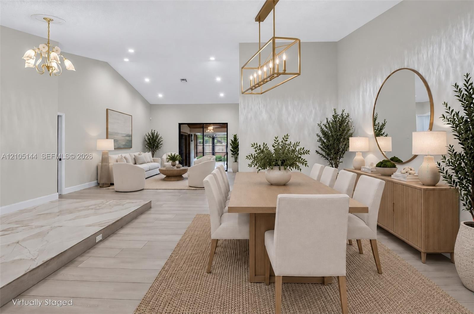 Vaulted ceilings, wood-finish flooring, recessed lighting, rectangular metal-frame pendant chandelier, and multi-panel sliding glass door