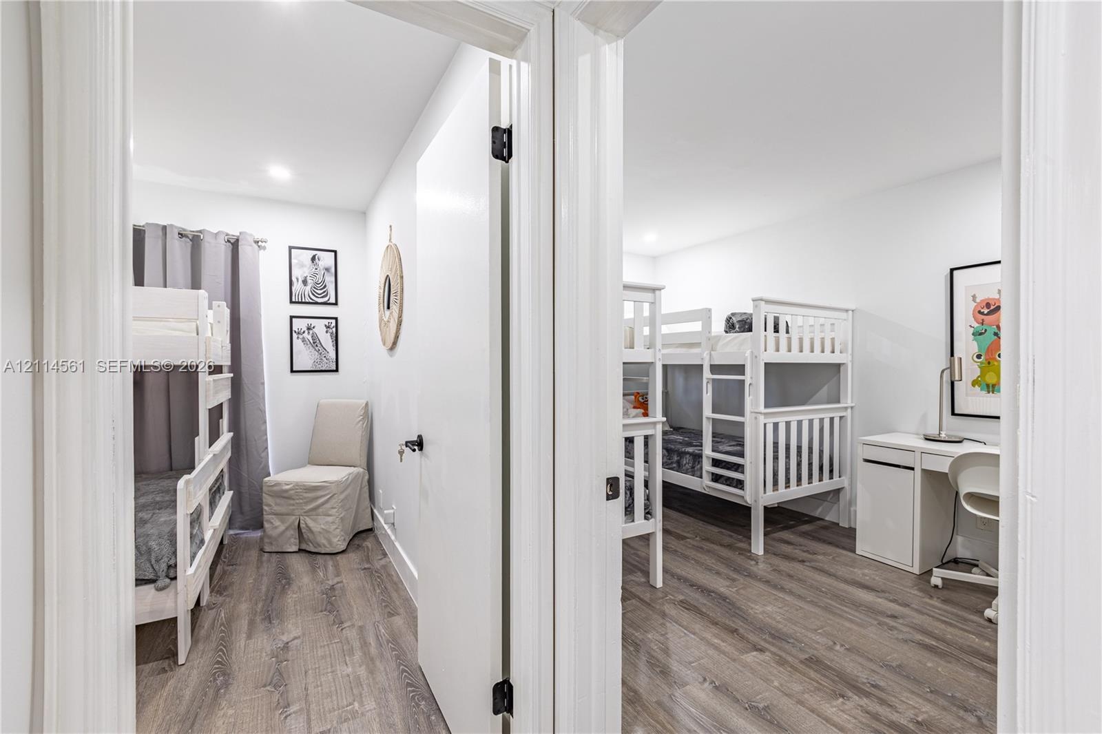 Interior rooms featuring wood-finish flooring, recessed lighting, and solid core doors with matte black hardware
