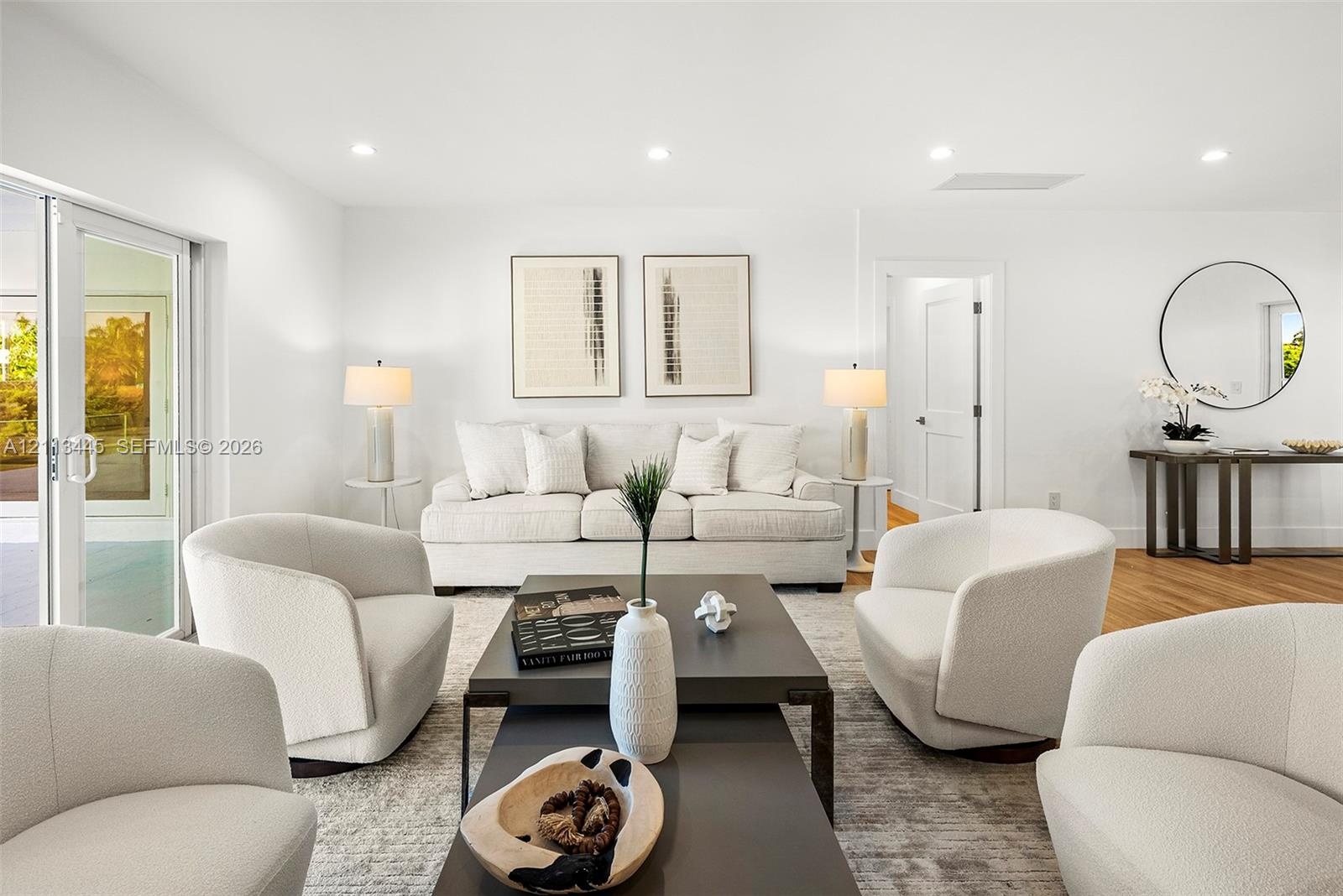 Living area featuring wood-finish flooring, recessed lighting, and a sliding glass door