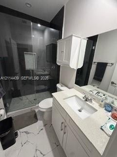 Bathroom featuring a glass-enclosed shower with tile surround, white cabinetry, integrated sink with stone-finish countertop, and large-format porcela