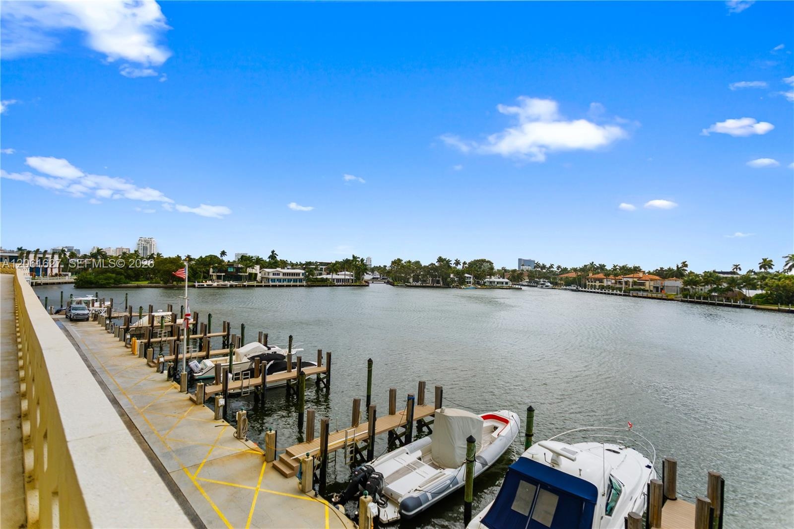 Waterfront property featuring a concrete bulkhead, deep-water dockage, and multiple boat slips