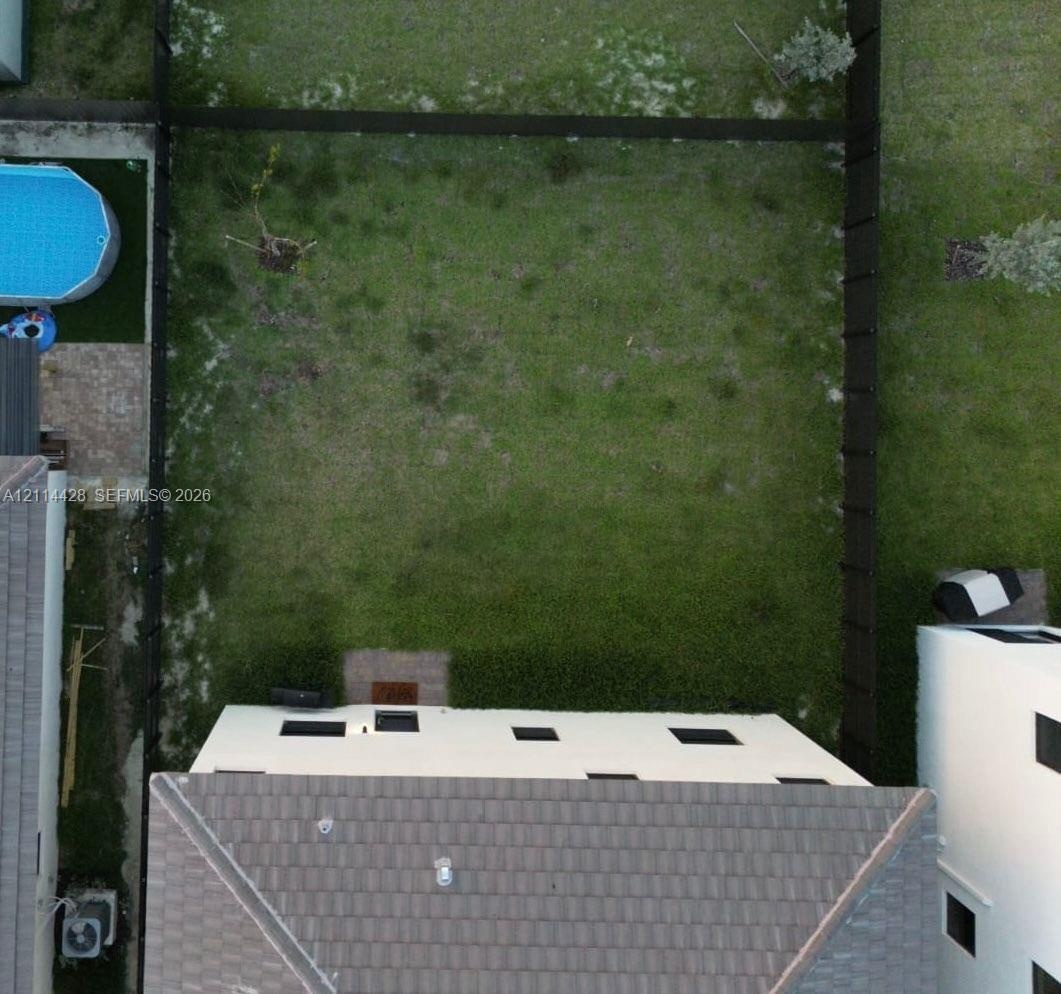 Fenced backyard featuring a grass lawn and paver patio