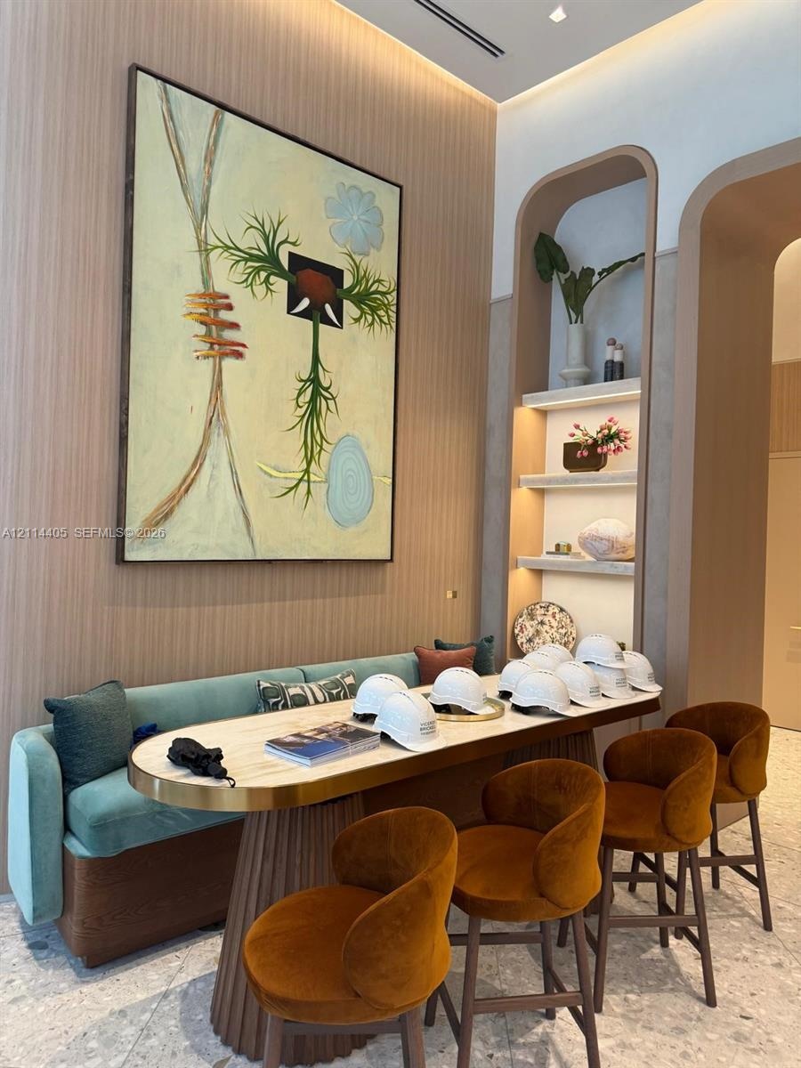 Vertical wood-slat wall paneling, built-in recessed arched shelving with integrated lighting, and terrazzo flooring