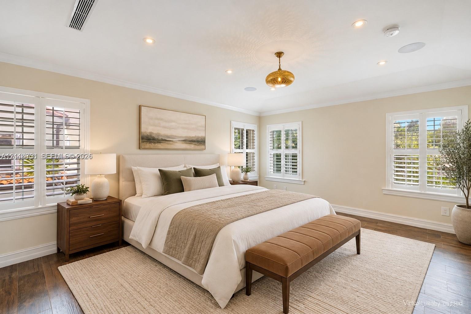 Interior space featuring wood-finish flooring, recessed lighting, crown molding, plantation shutters, and a decorative pendant light fixture