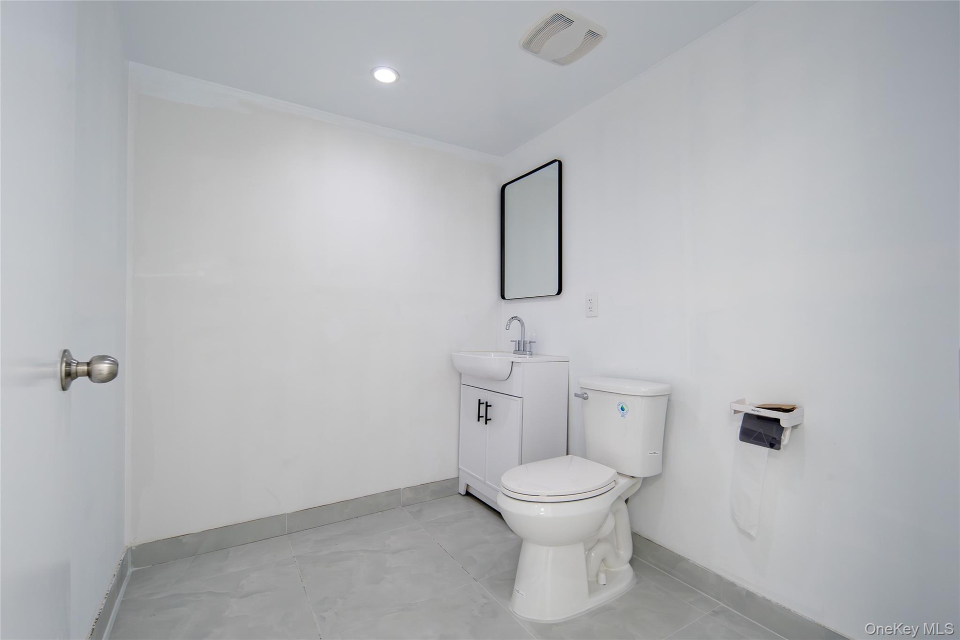Bathroom with vanity, tile patterned flooring, and recessed lighting