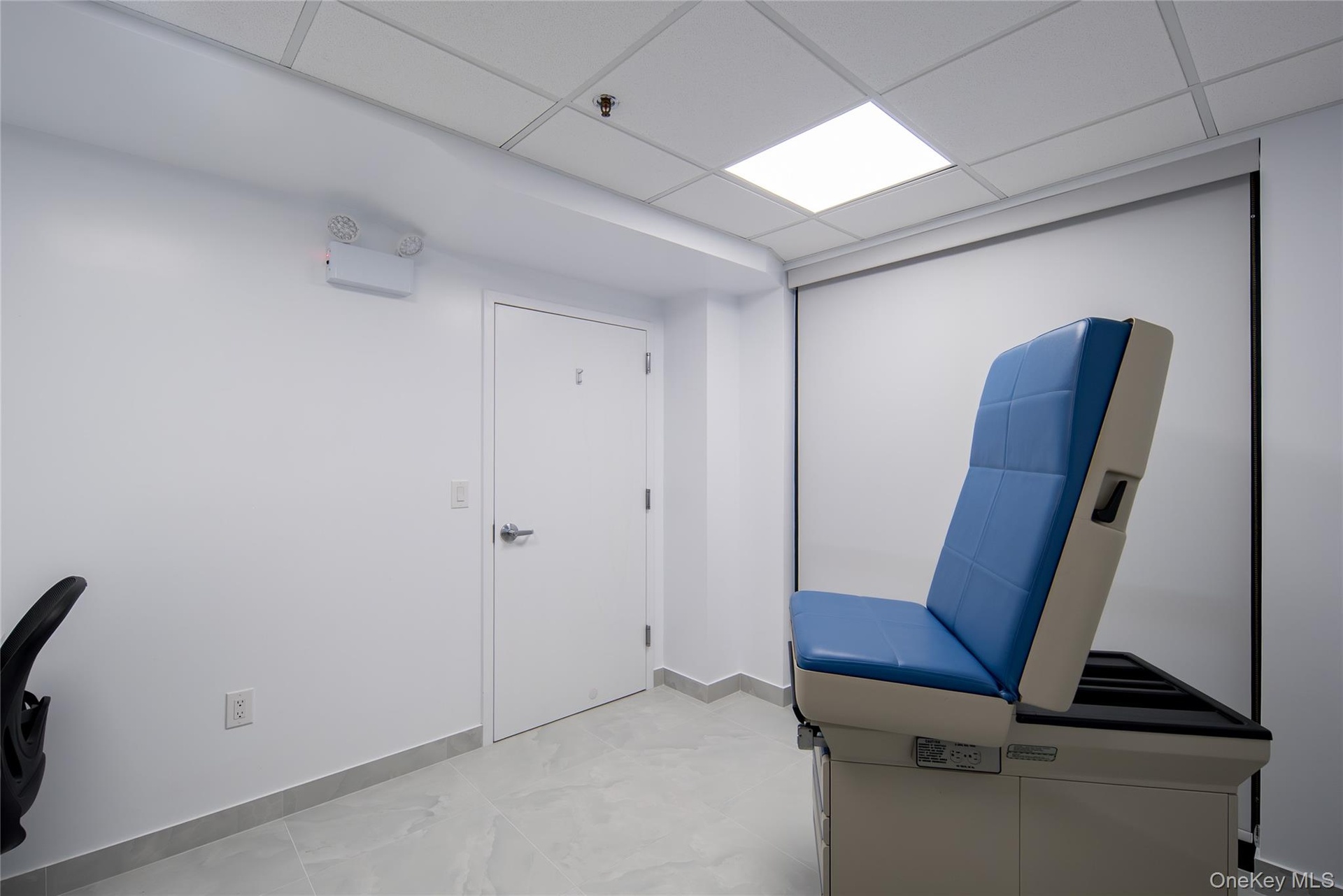Unfurnished office featuring a drop ceiling