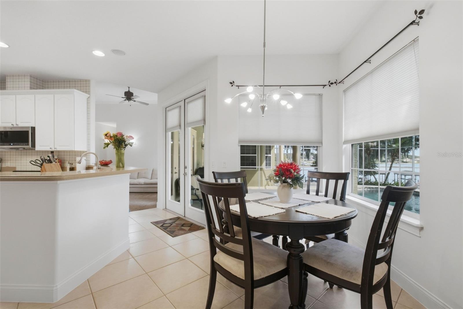 Dining in kitchen with lake and pool view