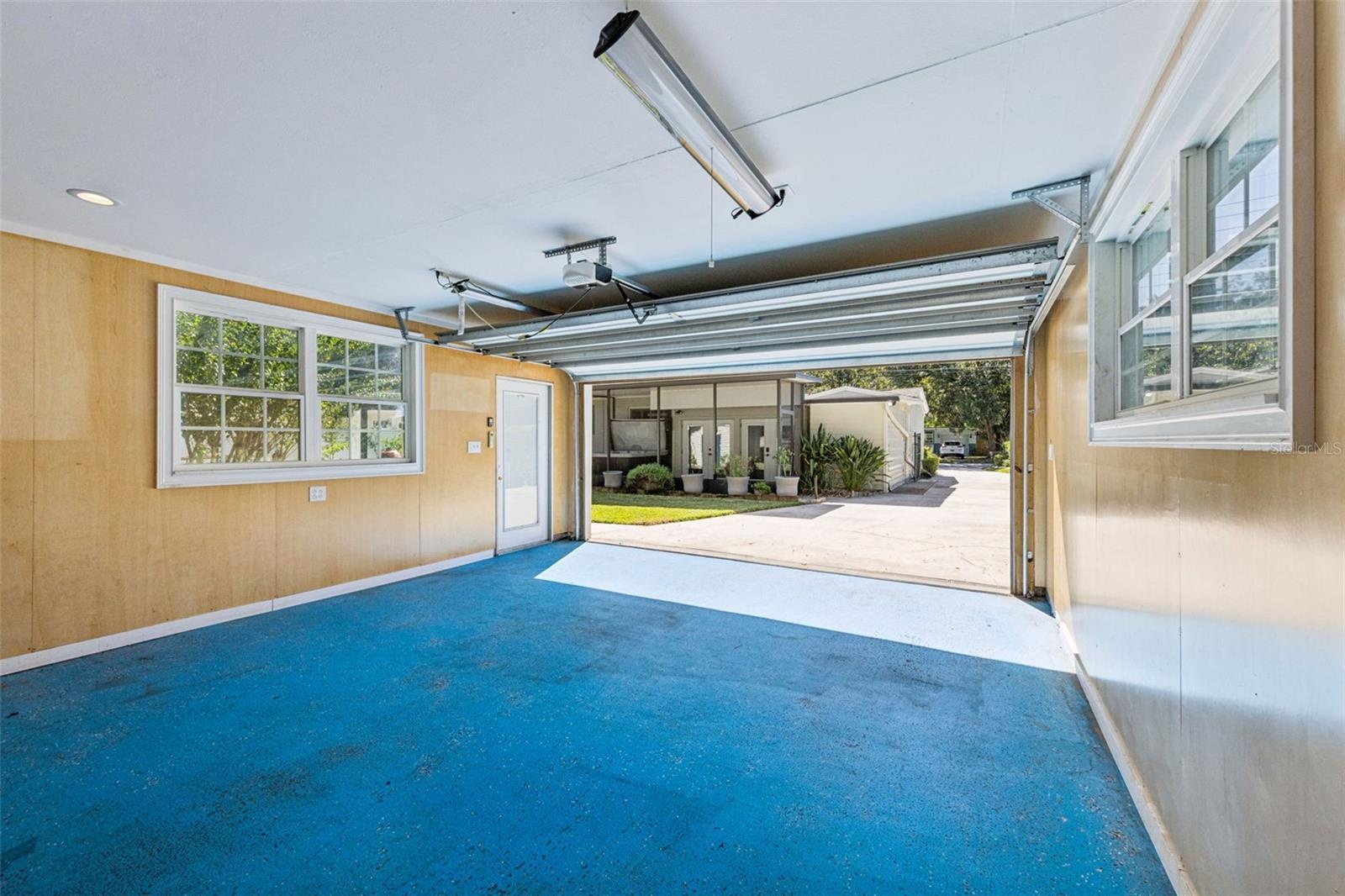 This view shows the long extended driveway that could hold 8 cars ! views of the screen porch and hot tub