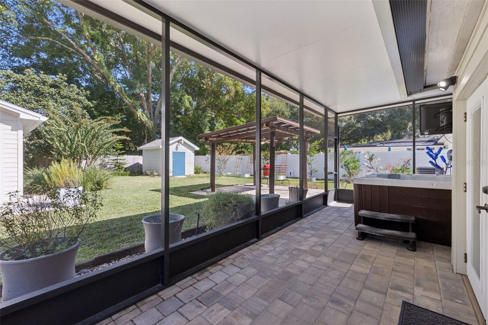 Screen porch views overlooking the hot tub and fully fenced backyard.
