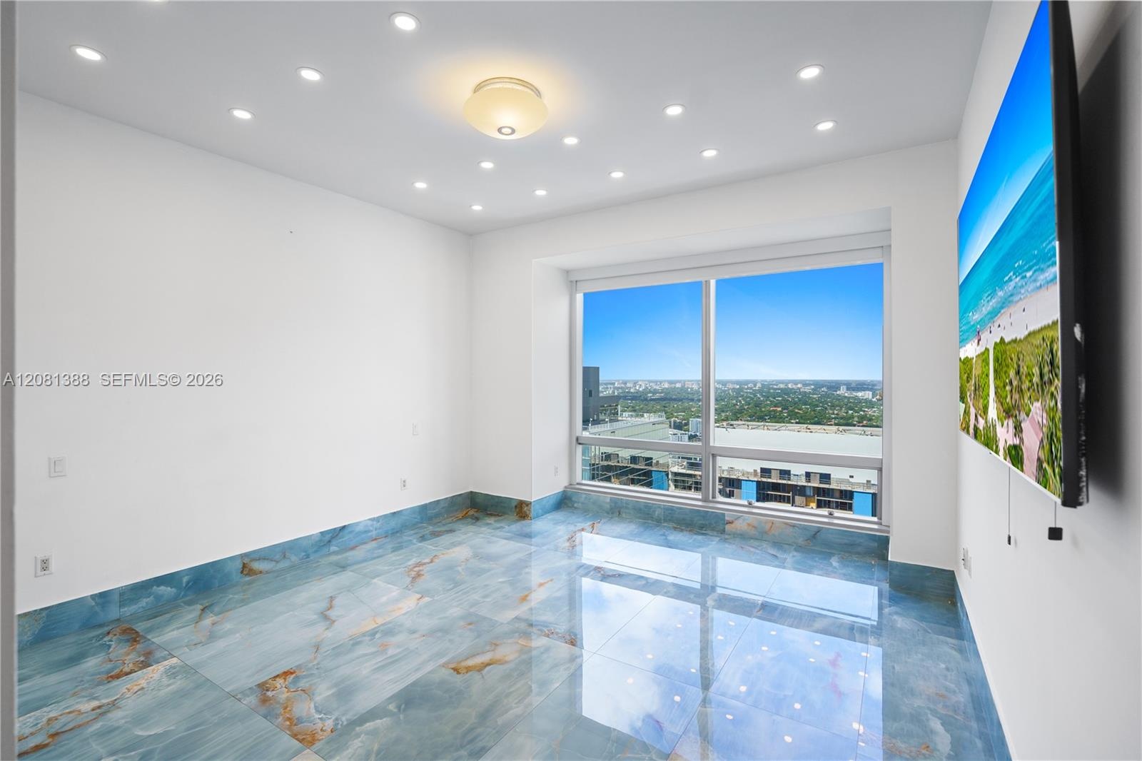 Polished blue stone flooring with veining, expansive floor-to-ceiling windows, recessed ceiling lighting, and a central dome fixture