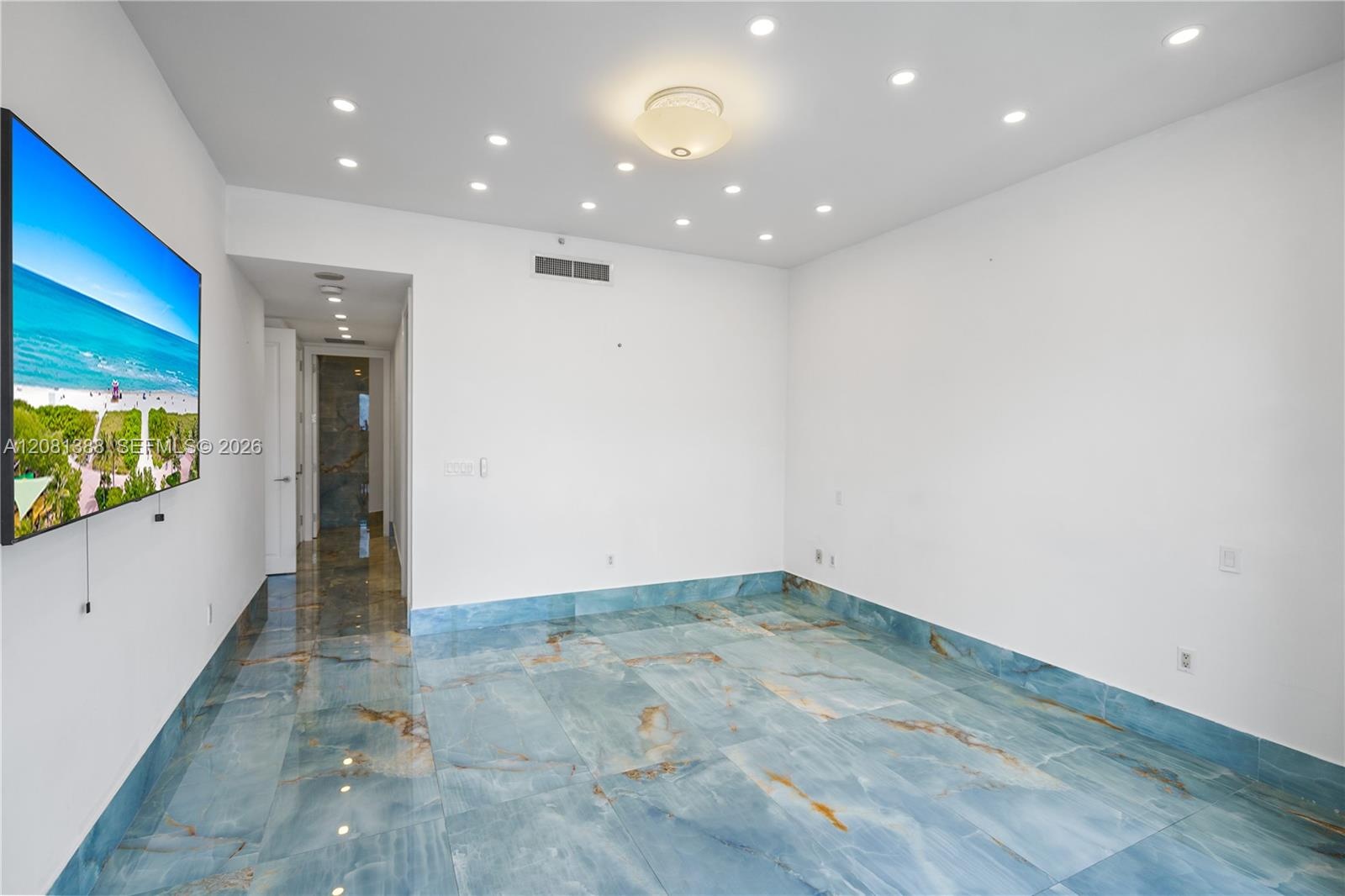 Polished blue stone flooring, recessed ceiling lighting, and a central flush-mount light fixture