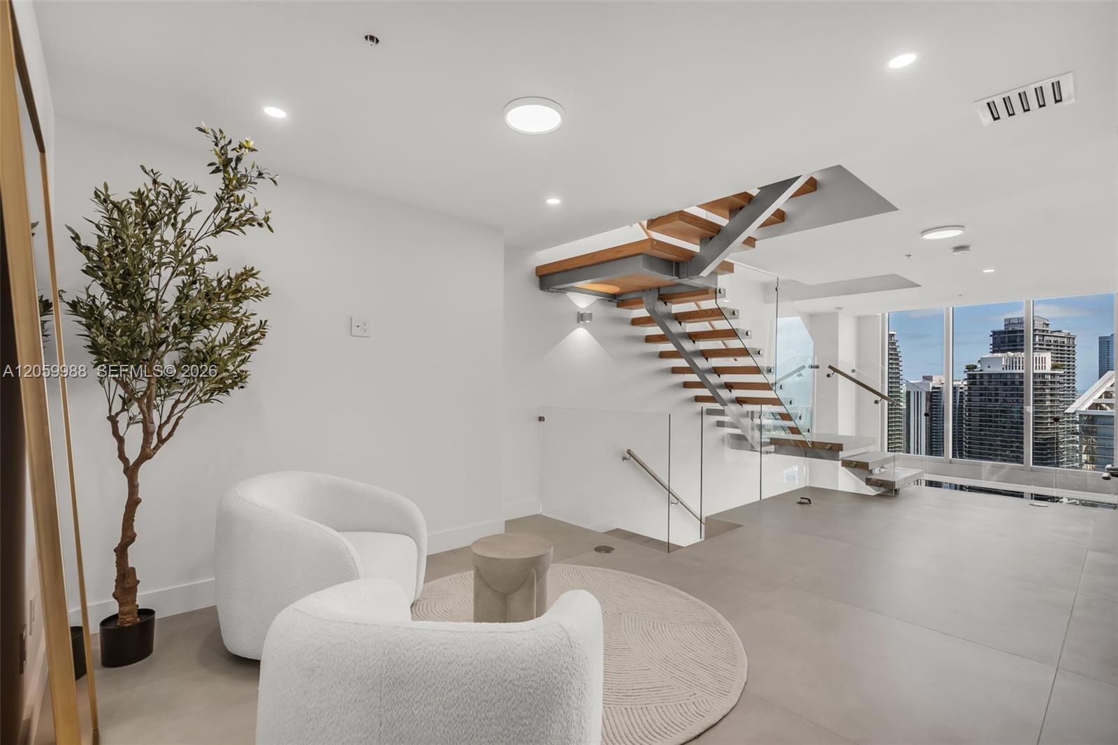 Floating staircase featuring wood treads, metal stringers, and glass railings, accented by floor-to-ceiling windows, recessed lighting, and large-form