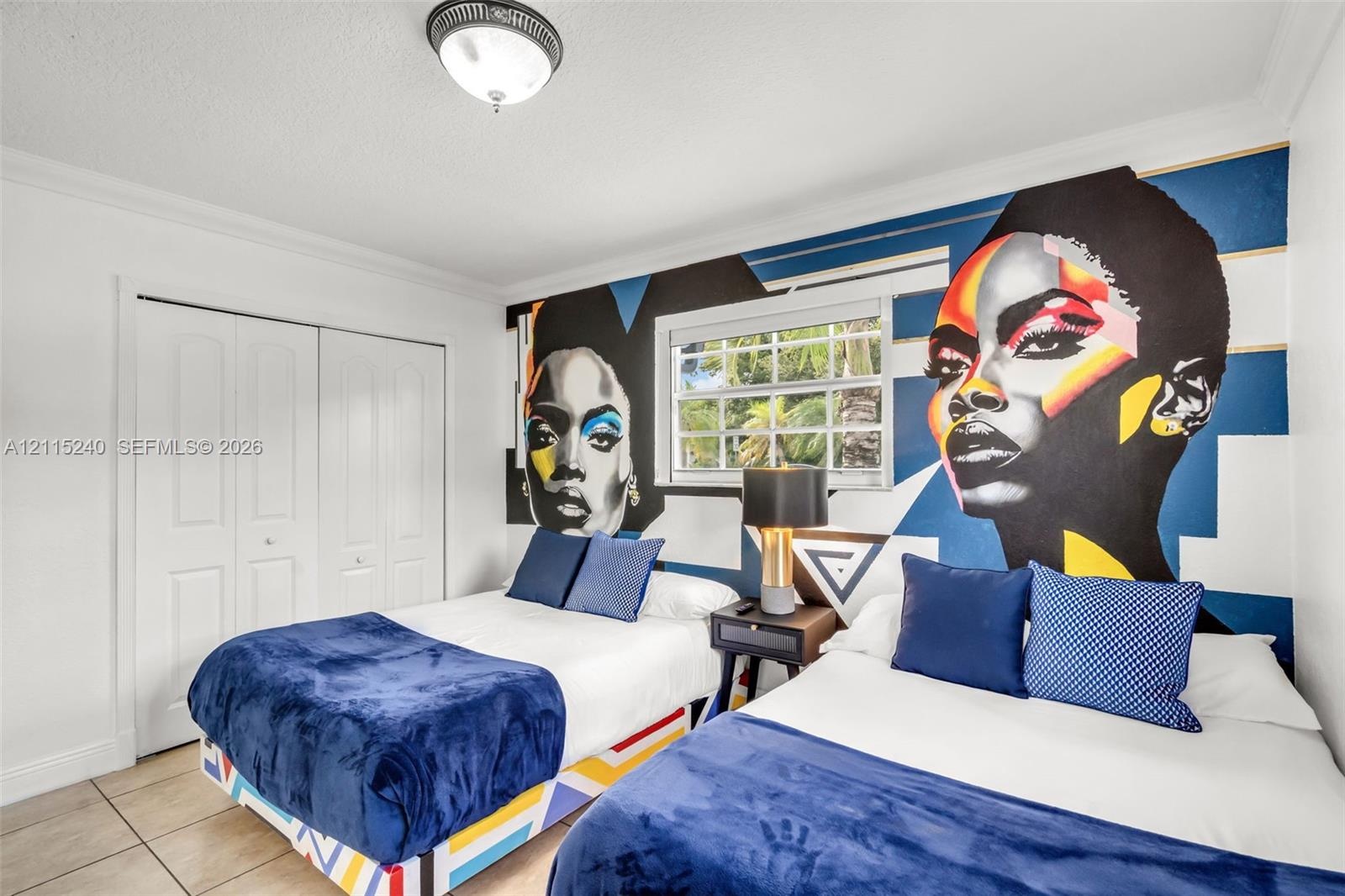 Room featuring large-format ceramic tile flooring, double-door closet with paneled detailing, dual-pane window with muntins, and a semi-flush mount ce