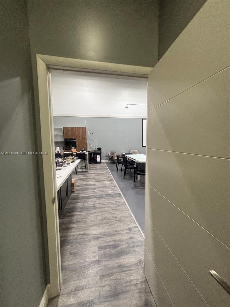Horizontal panel door, wood-finish flooring, and built-in cabinetry