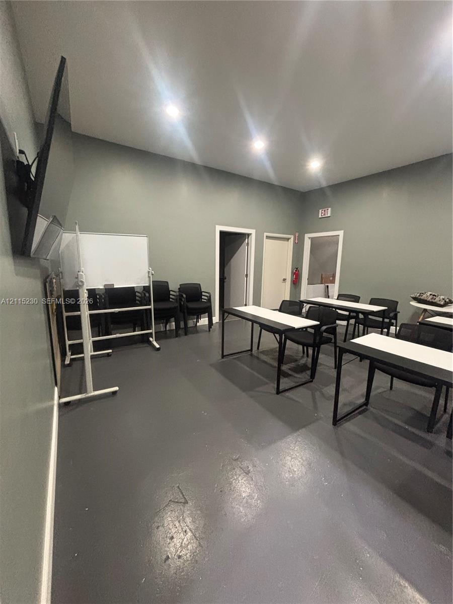 Interior room featuring painted walls, solid-surface flooring, and recessed lighting