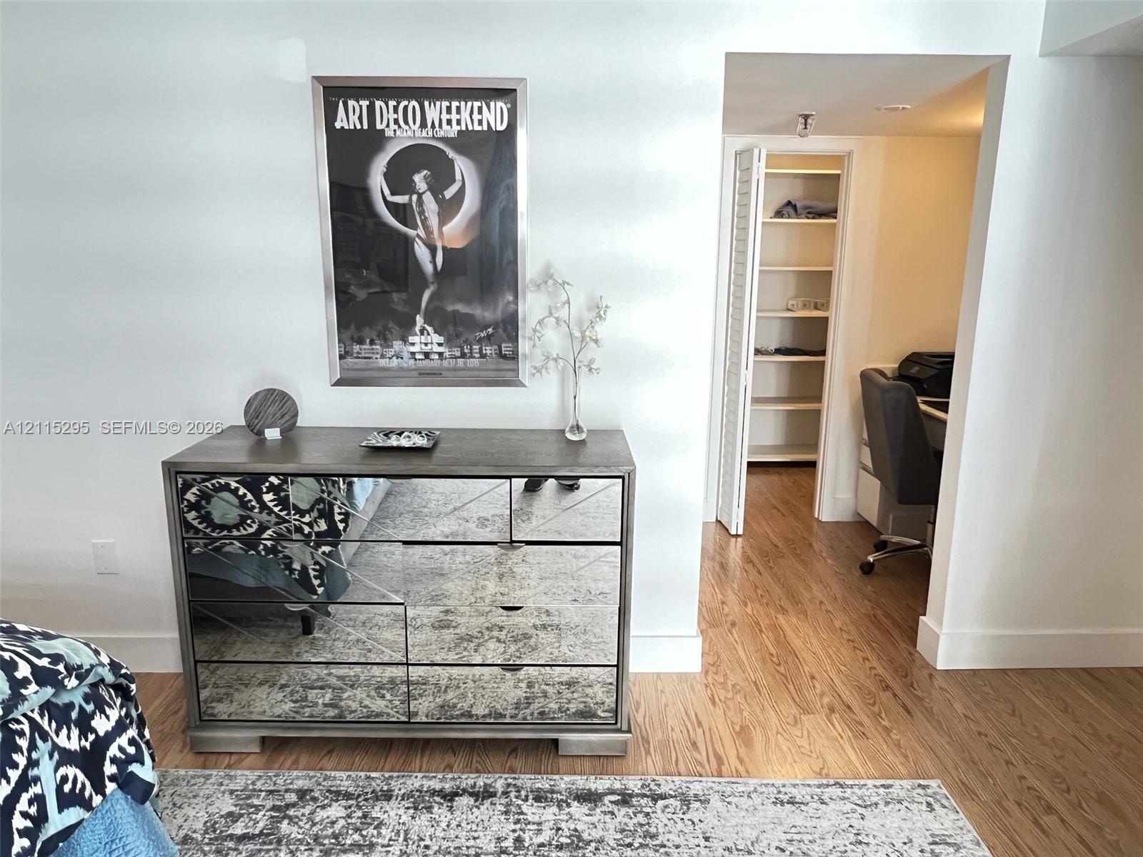 Wood-finish flooring and walk-in closet with built-in shelving