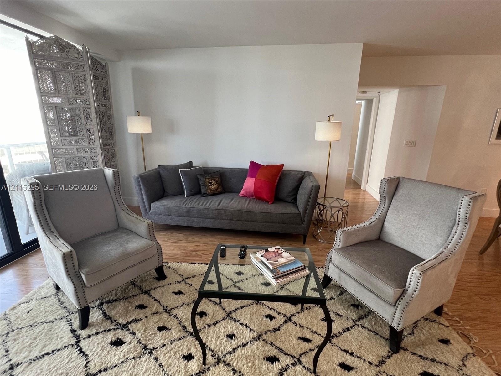 Living area featuring wood-finish flooring and neutral wall paint