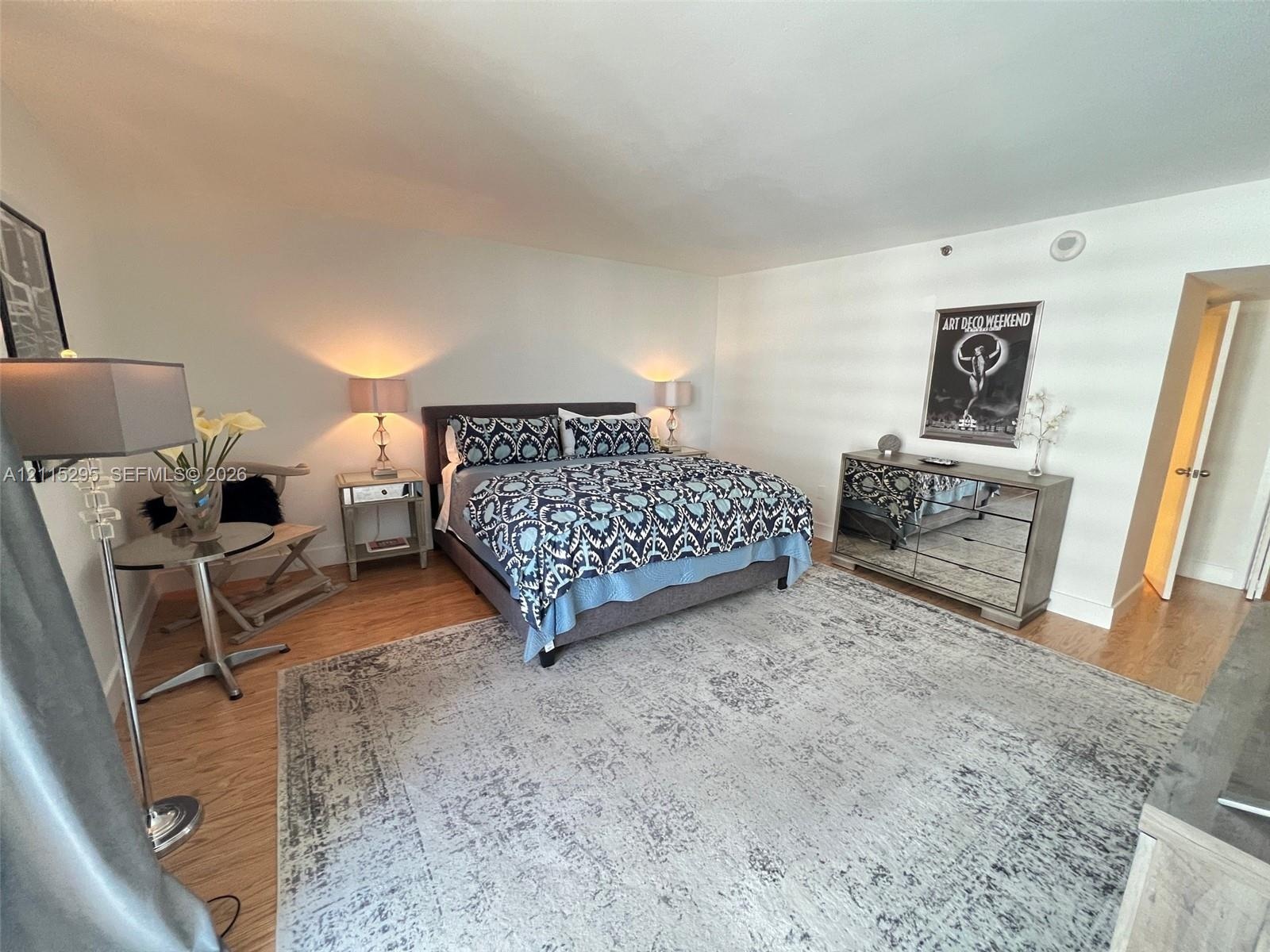 Spacious room featuring wood-finish flooring and neutral-toned walls