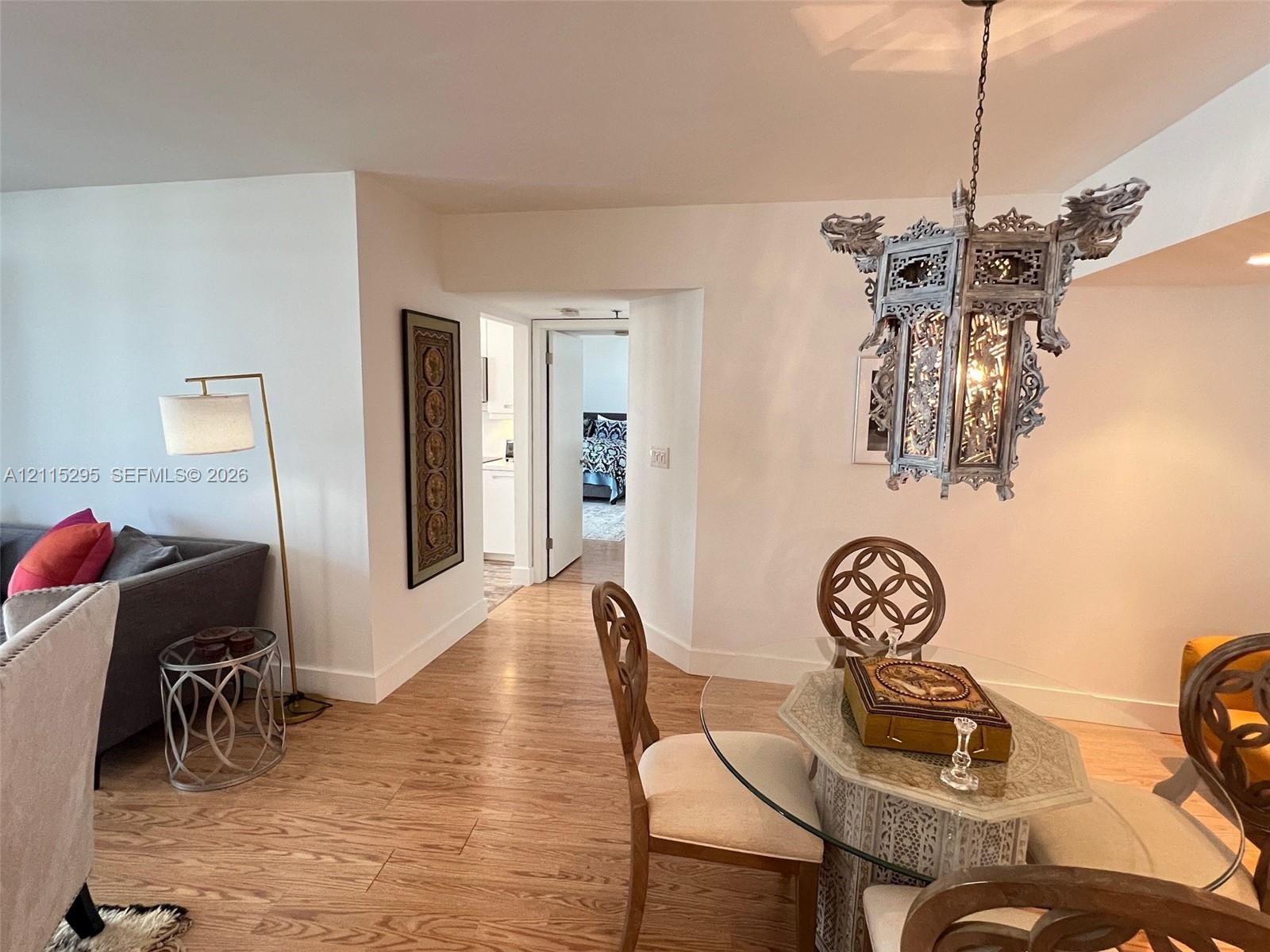 Wood-finish flooring and intricate metal lantern-style chandelier