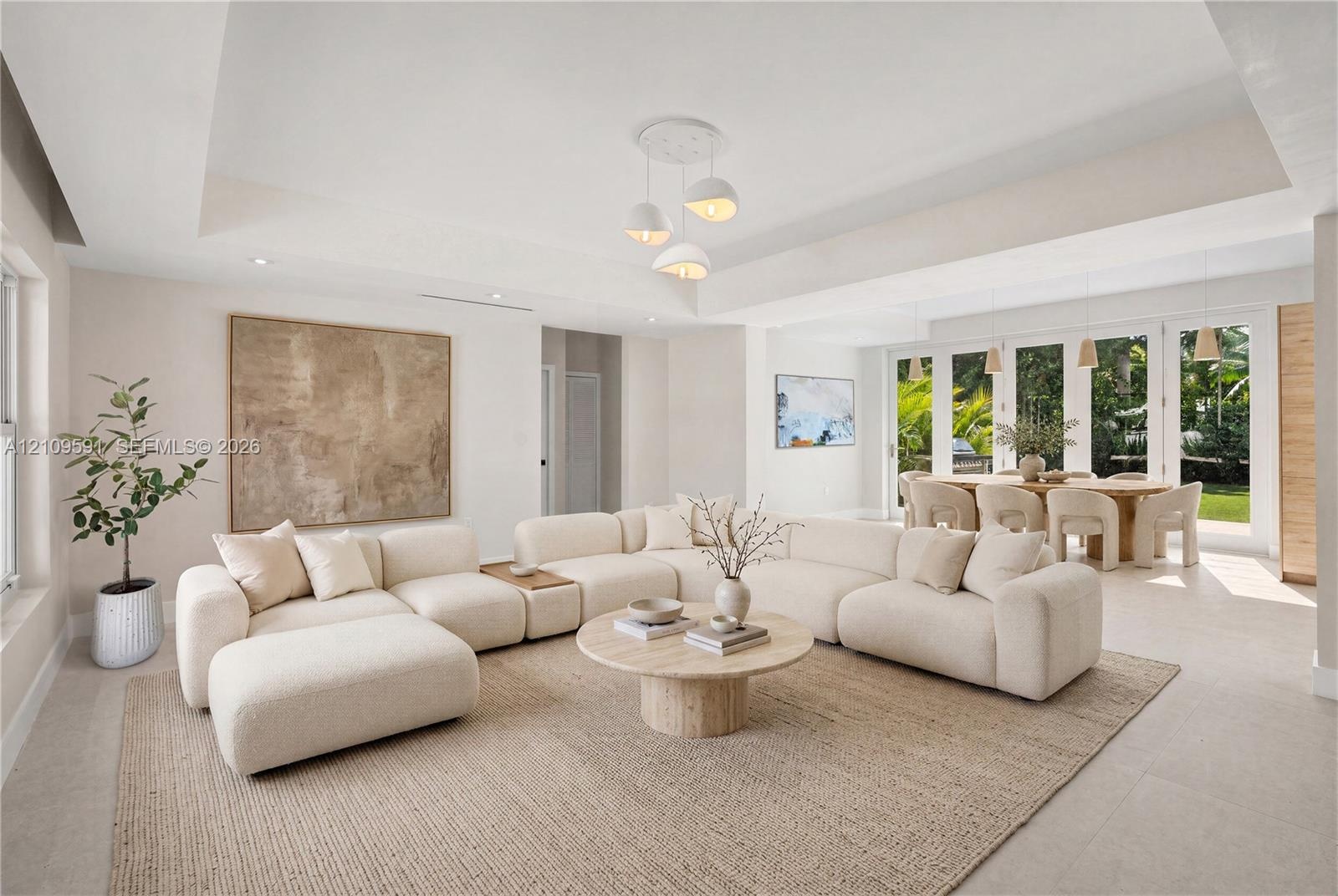 Virtually Staged: Tray ceiling, large-format tile flooring, multi-pane glass doors, and contemporary pendant lighting