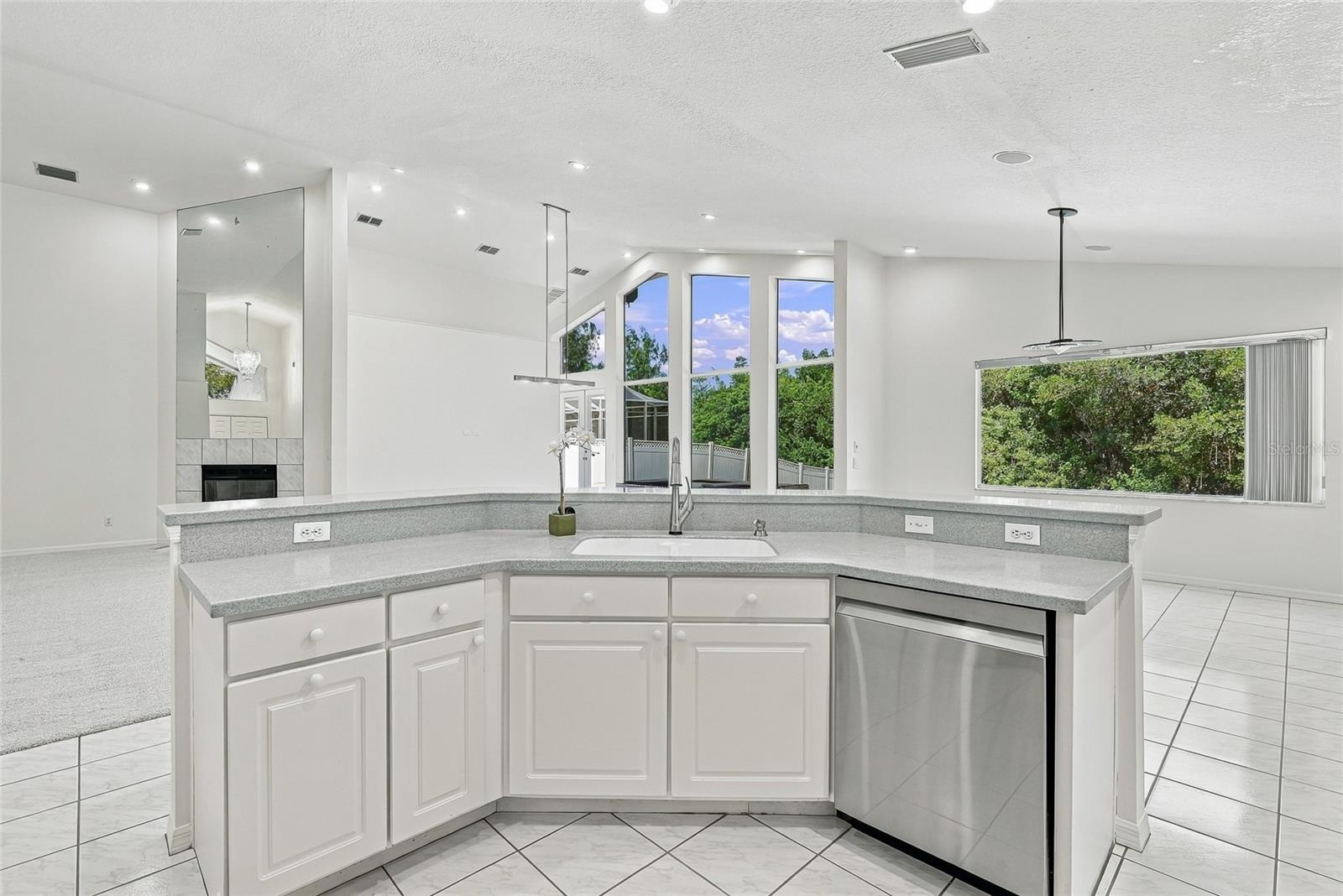 Open and spacious kitchen with breakfast bar for casual dining.