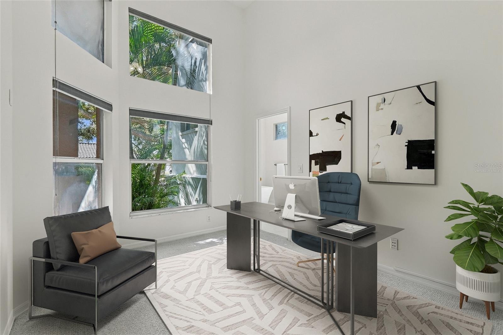 Adjacent to the primary bedroom and bath lies a separate office. Virtually staged.