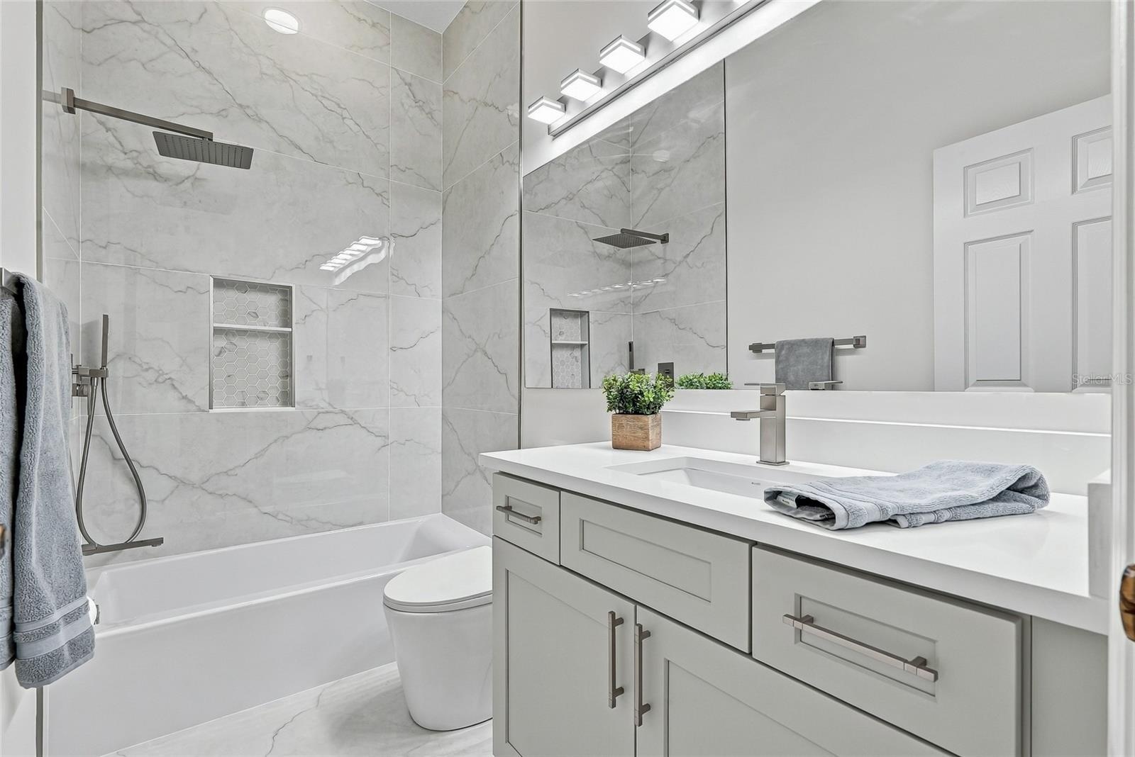 Full hall bath shared by bedrooms 3 and 4.