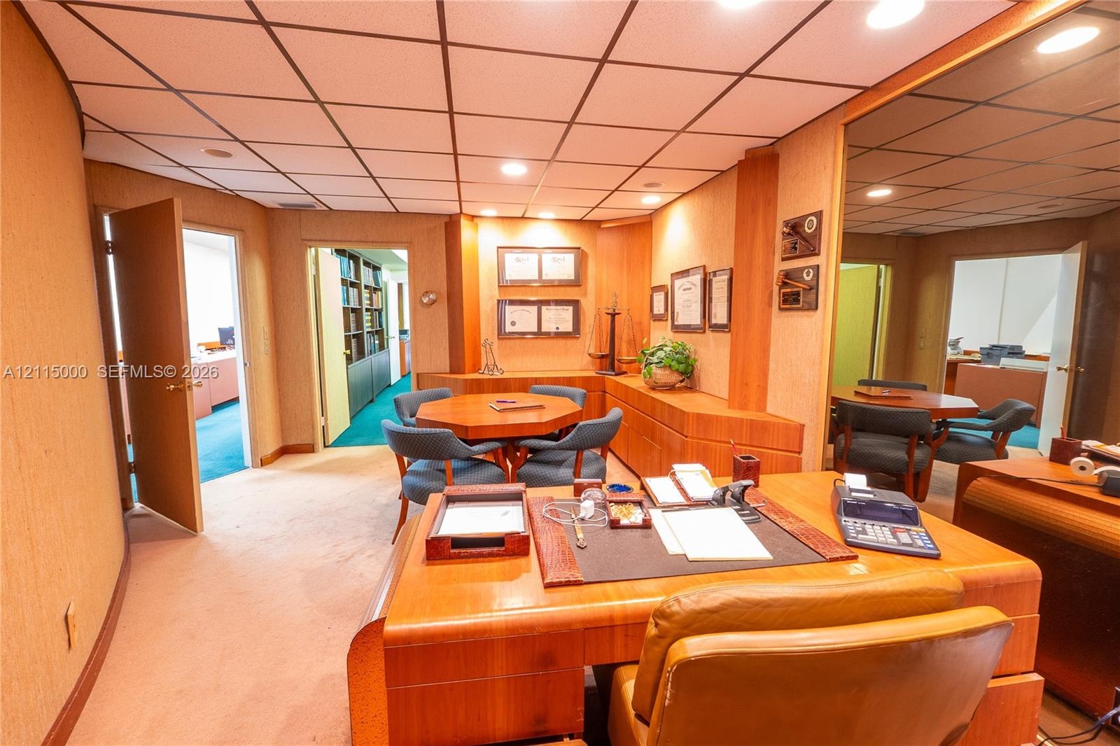 Custom built-in wood cabinetry, recessed lighting, drop ceiling, and wall-to-wall carpeting