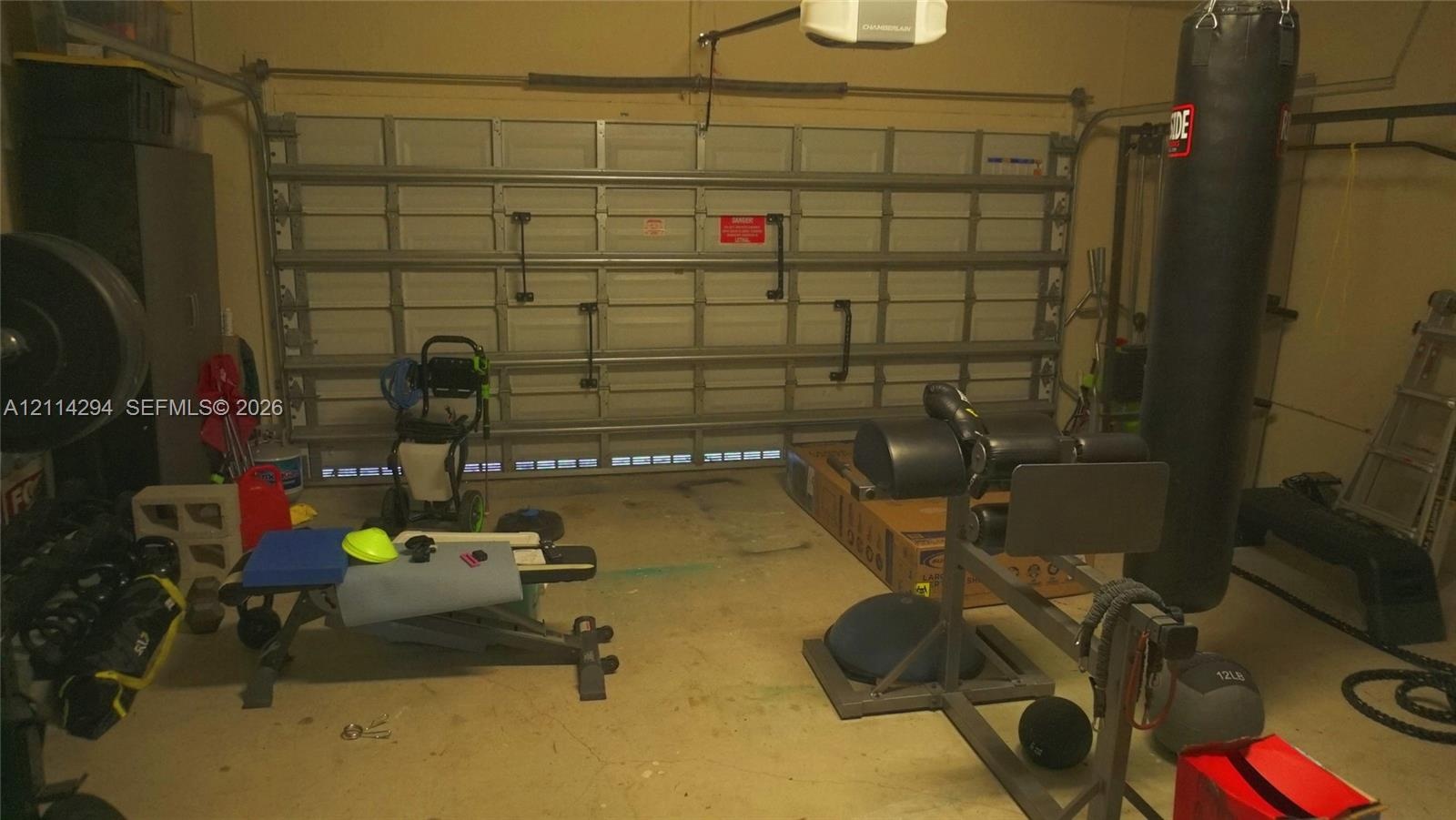 Enclosed garage featuring a multi-panel overhead door and ceiling-mounted garage door opener