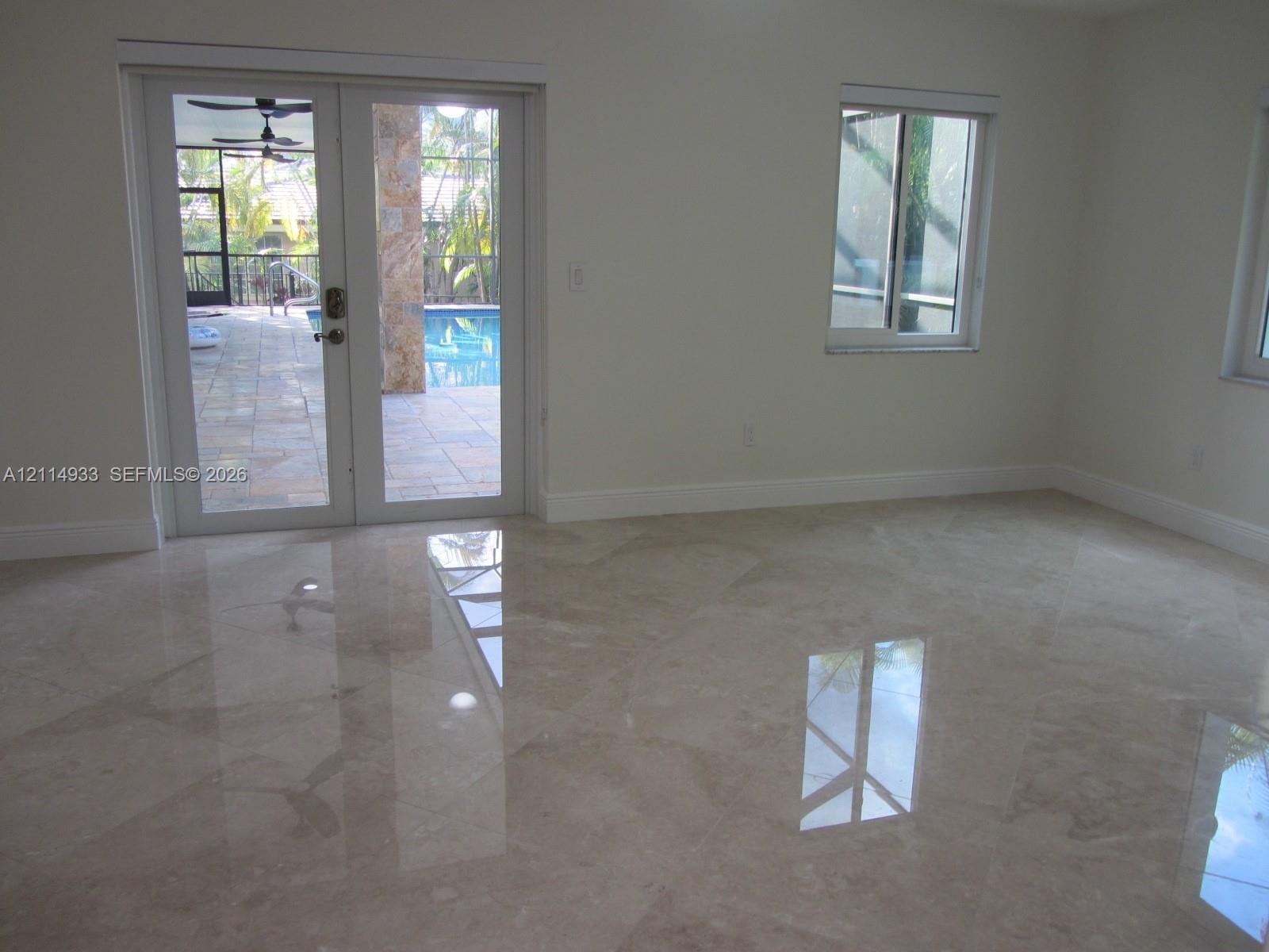 Polished stone flooring, double-pane sliding glass doors, and dual-pane windows