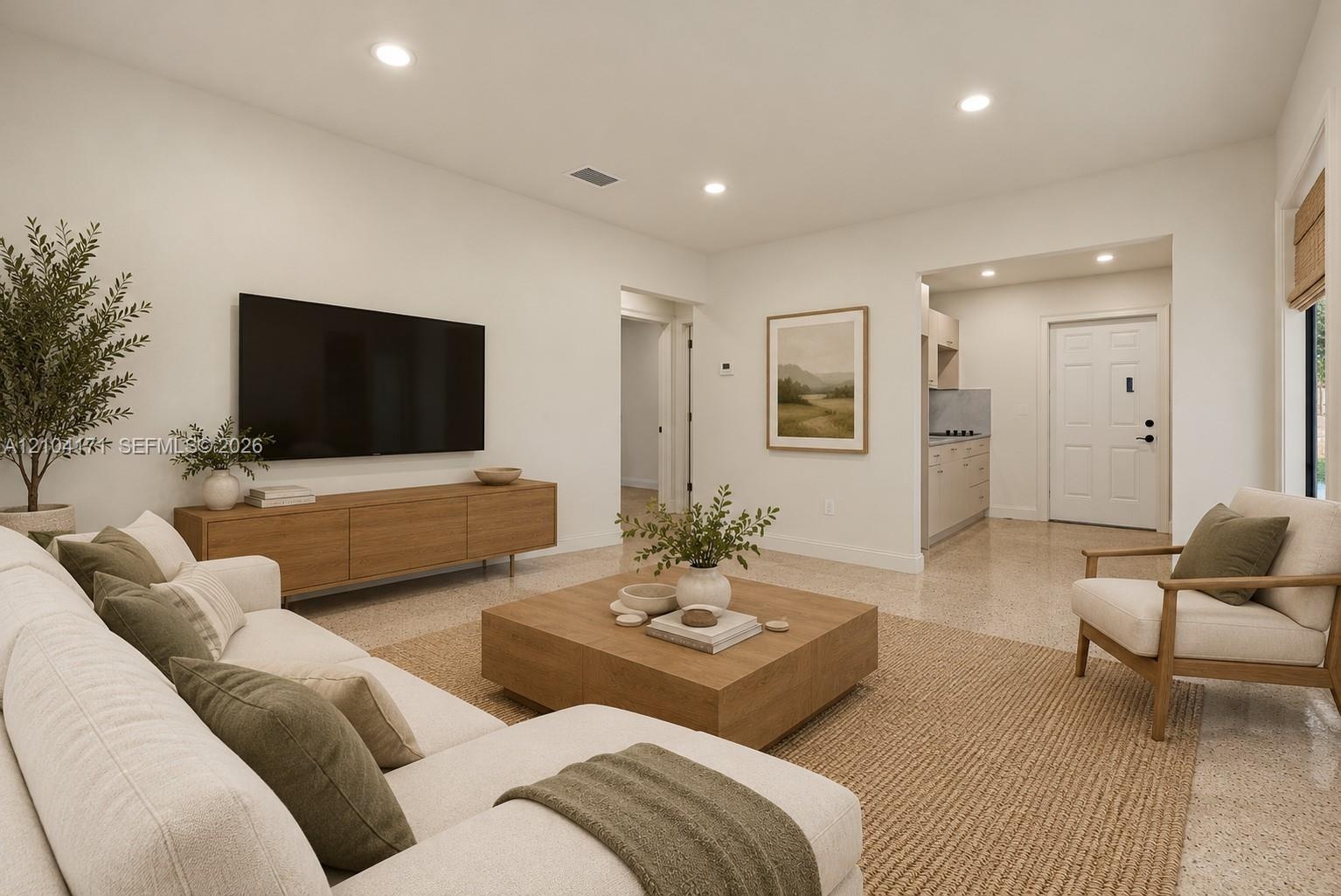 Neutral interior space featuring recessed ceiling lighting, textured wall finish, and a centered window with woven wood shade